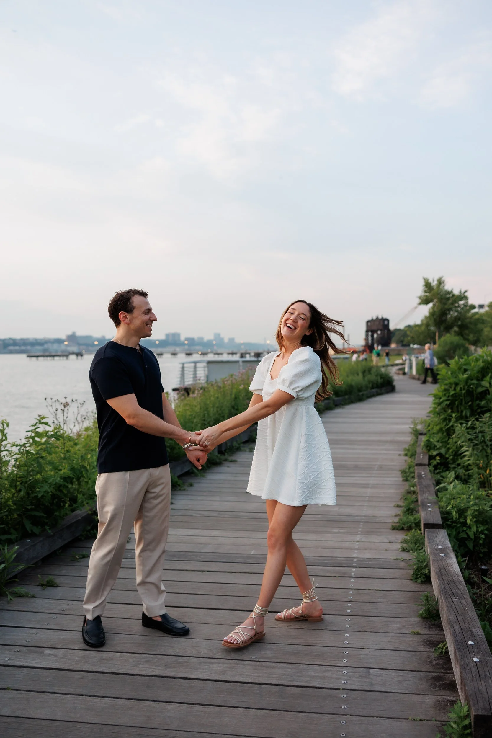 A couple dancing together on a wooden pier