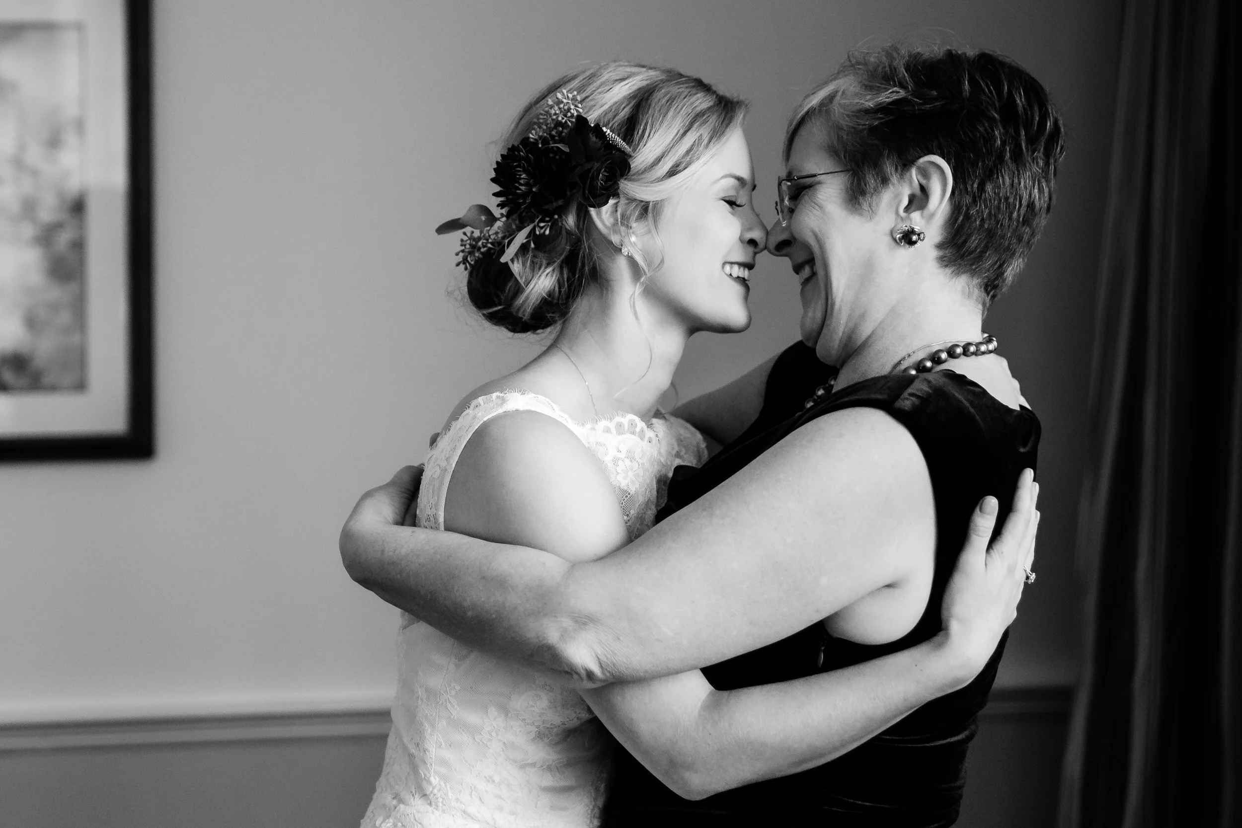 Two people hugging and standing nose to nose