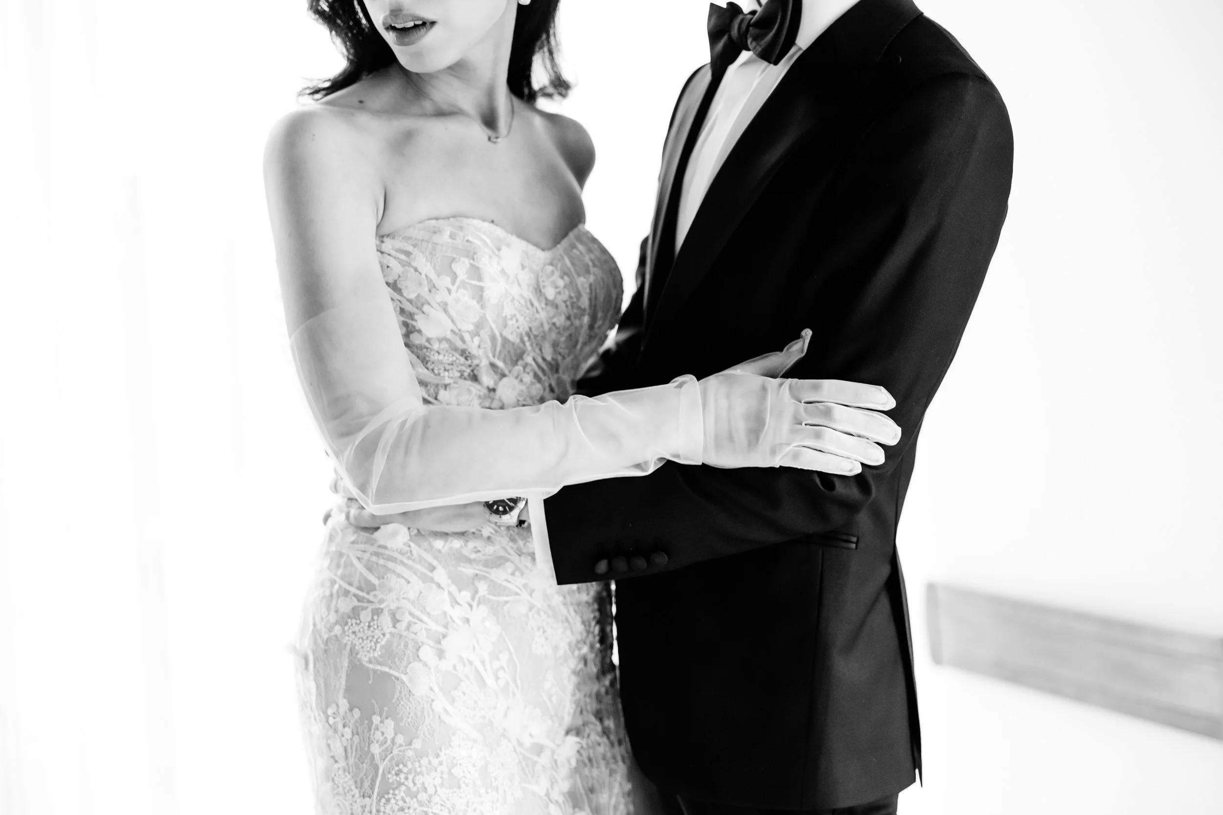 A close up of newlyweds with their arms around each other 