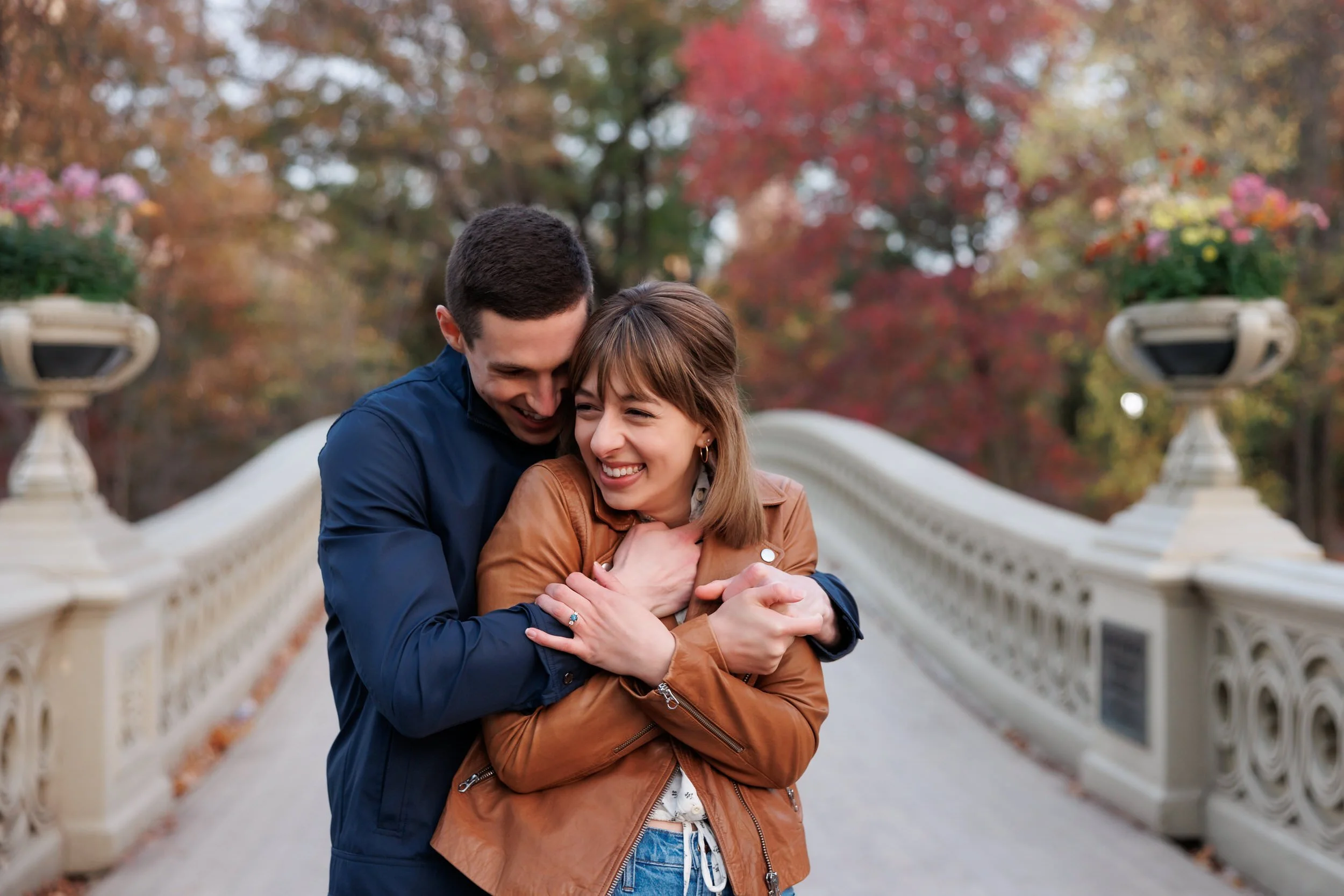 A person hugging their partner from behind as they both smile