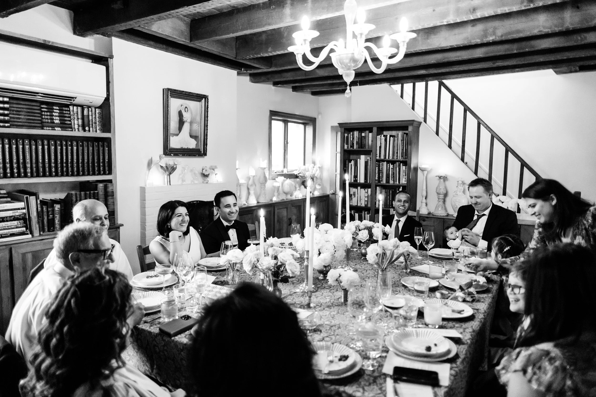 An intimate wedding reception around a long, rectangular table 