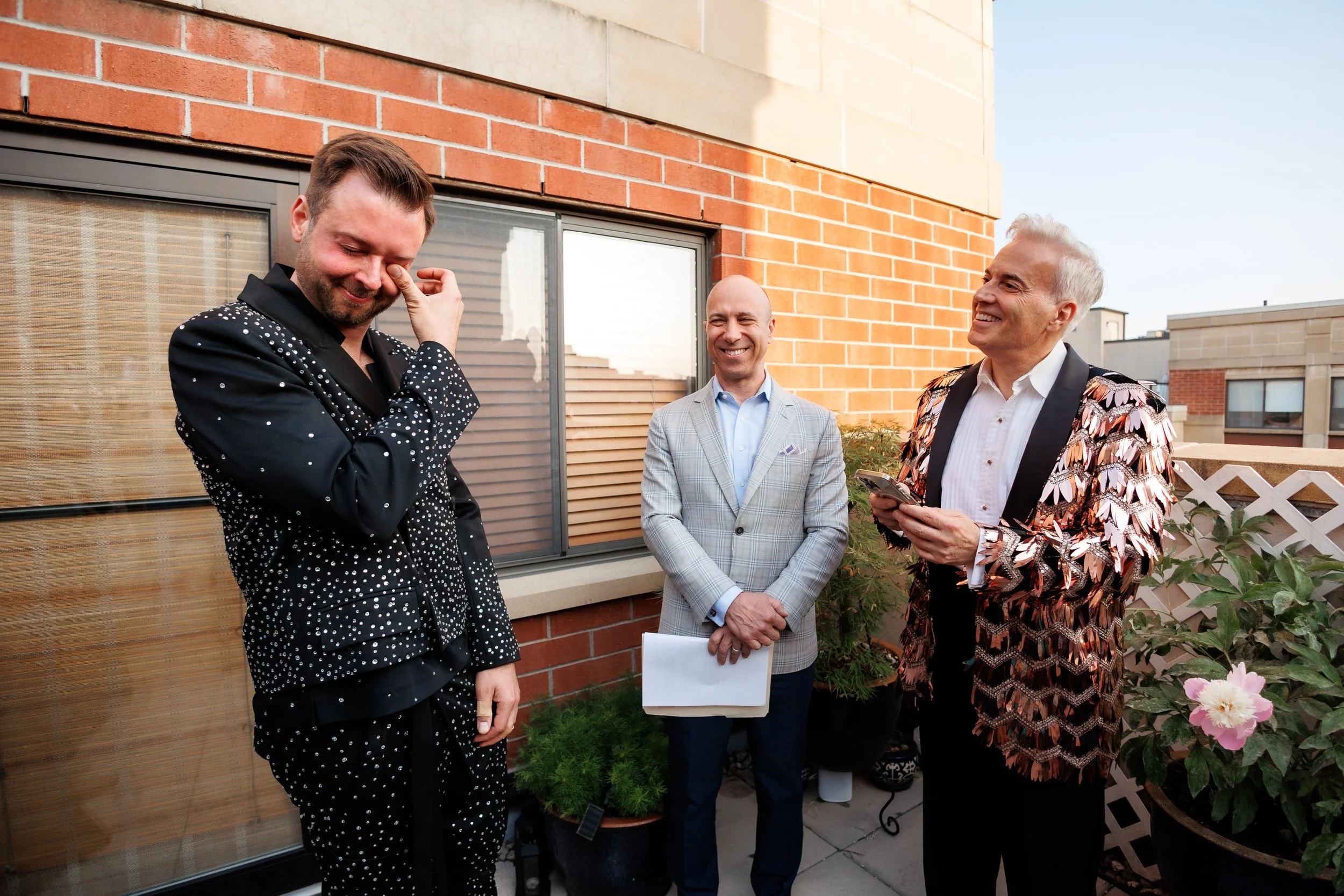 A person wiping a tear as their partner reads their vows 
