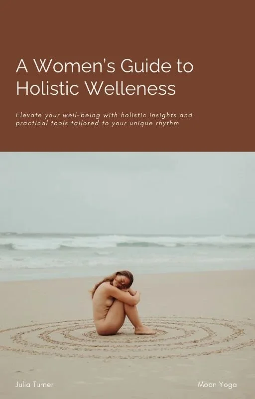A cover of a book titled "A Women's Guide to Holistic Wellness" shows a woman sitting on a sandy beach, hugging her knees, with the ocean in the background. An ebook for cyclical health, for women to connect with their cycle through yoga.