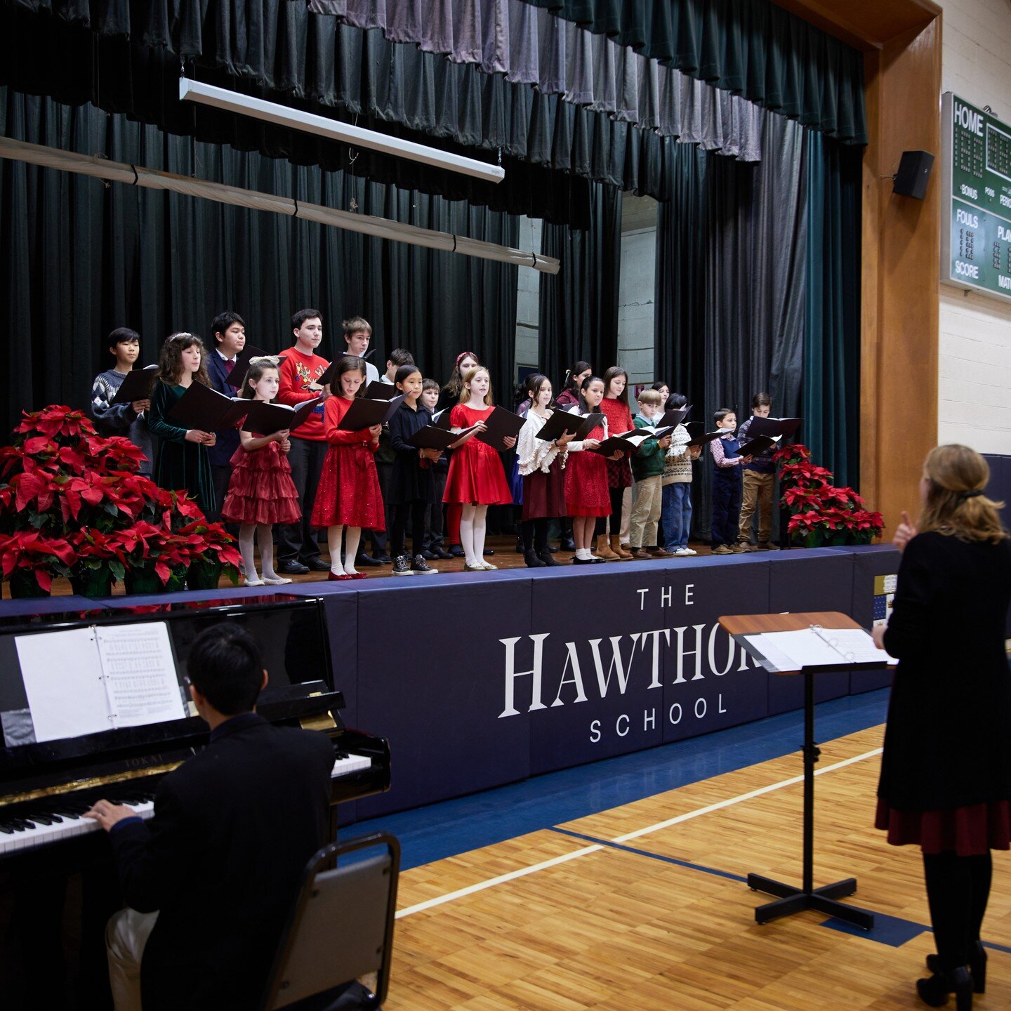On Sunday, December 9th, families gathered in the school gym for a festive afternoon to celebrate the coming of the Christmas season. The event began with a Chorus Club performance of several well-beloved Christmas Carols, such as &quot;God Rest Ye M