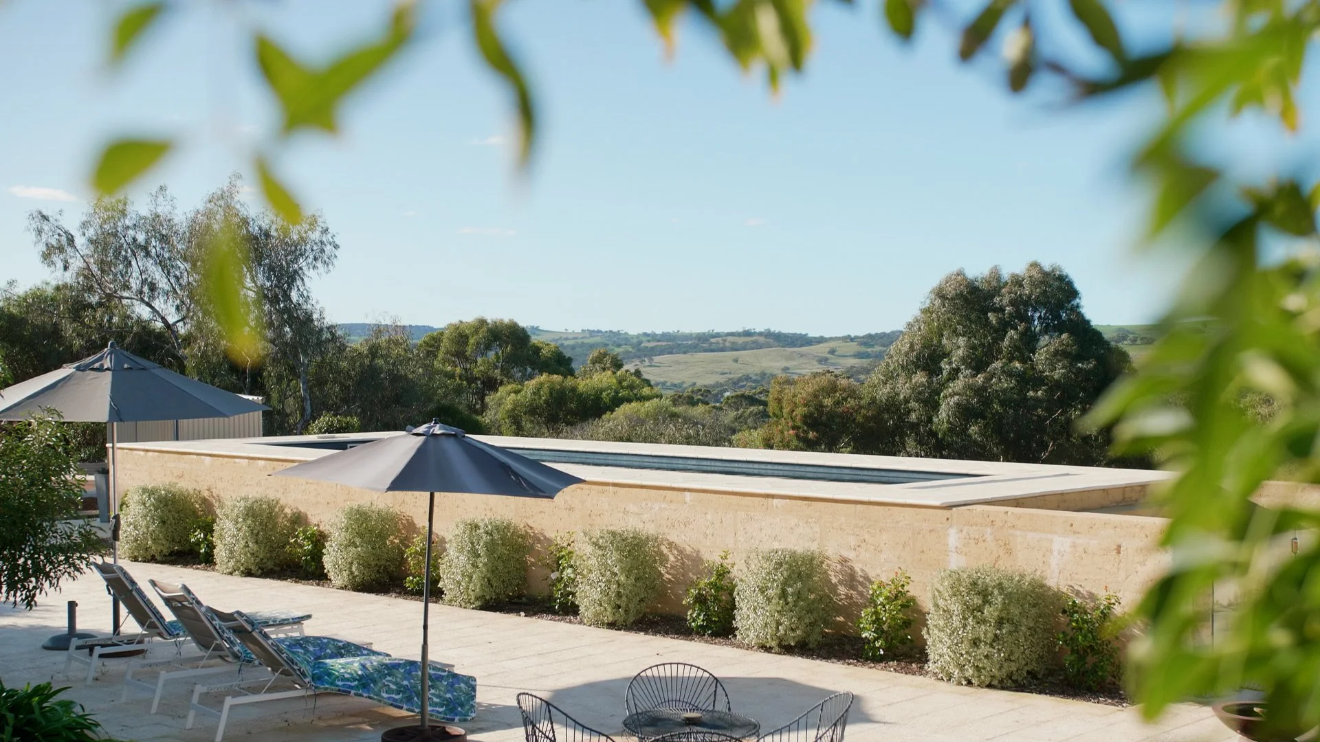 Raised fibreglass lap pool with limestone retaining wall and valley views in Toodyay