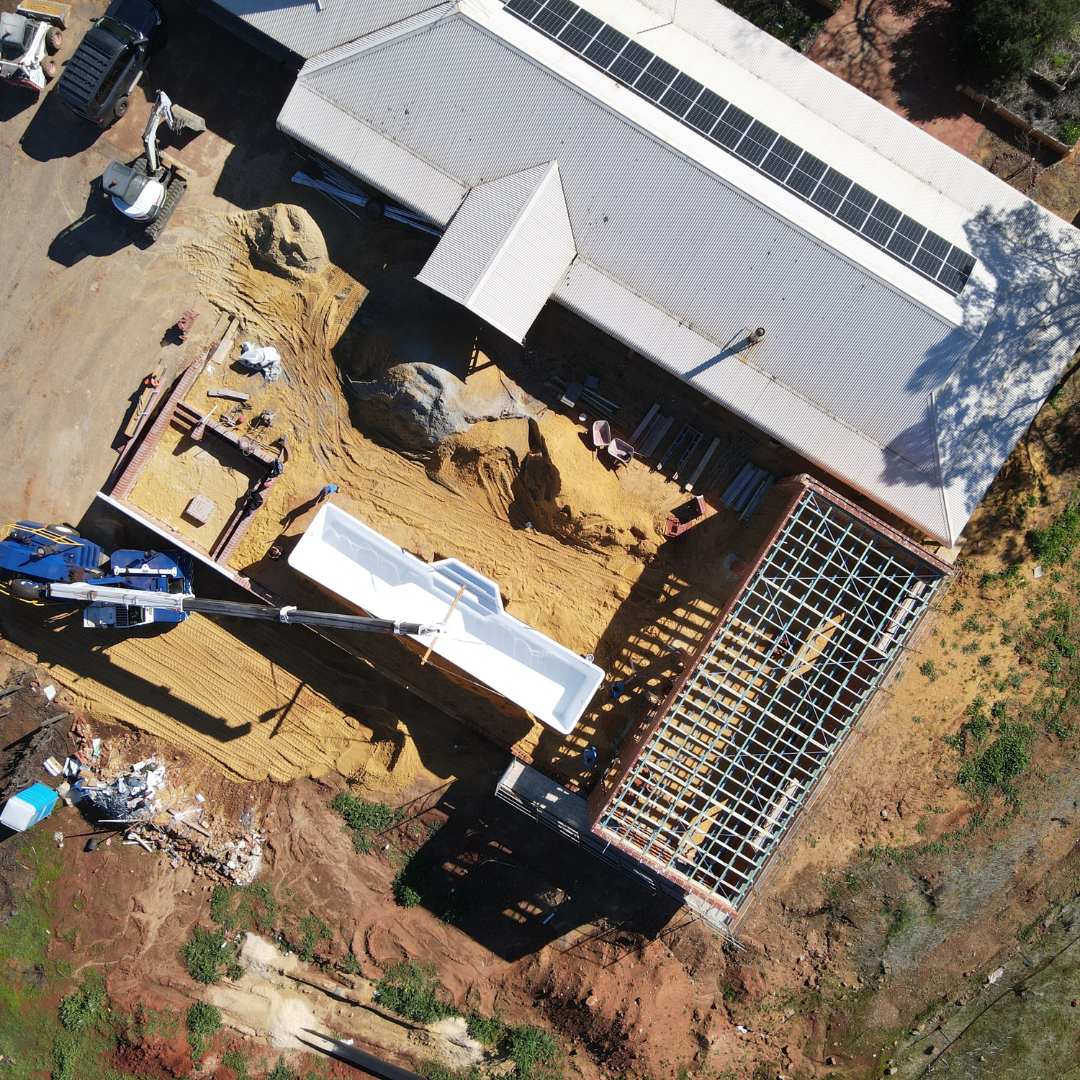 crane lifting fibreglass pool shell into position at bindoon property