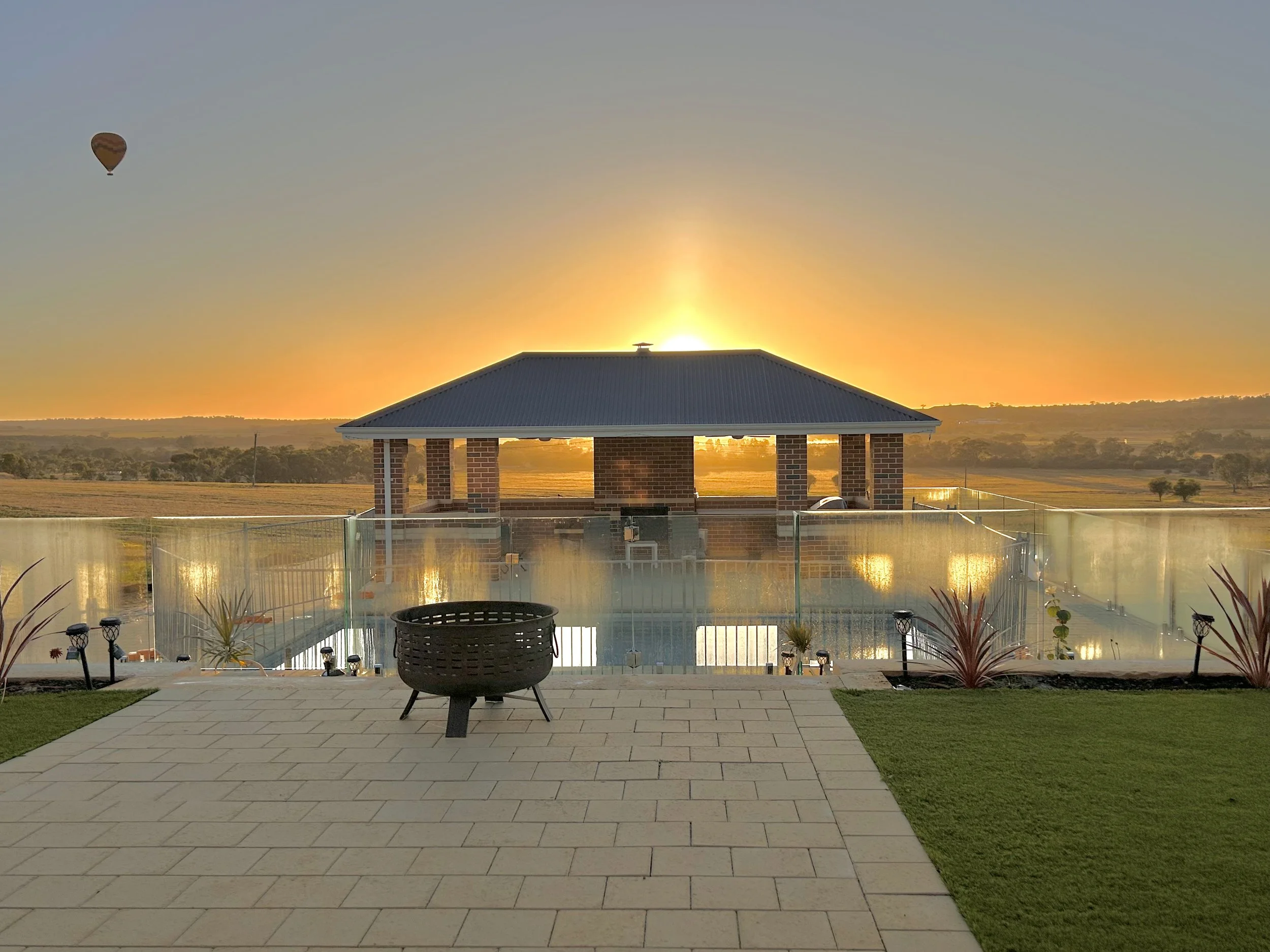 Fibreglass pool on a sloping Northam block with hot air balloons over the valley