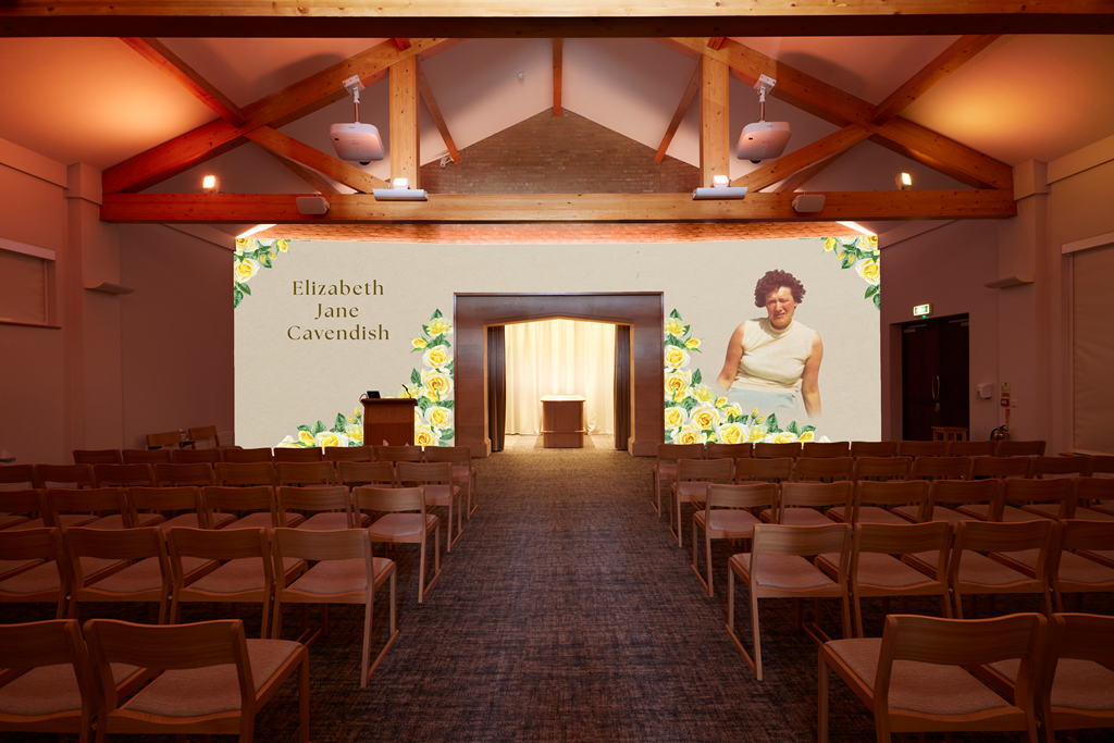An indoor event space set up for a memorial or presentation, with rows of chairs facing a large screen displaying the name Elizabeth Jane Cavendish and a photo of a woman, surrounded by decorative floral graphics.