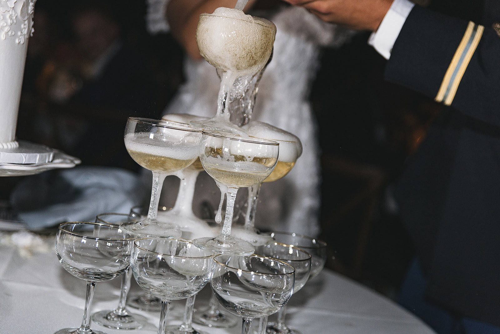 Champagne tower with cascading bubbles at an event.