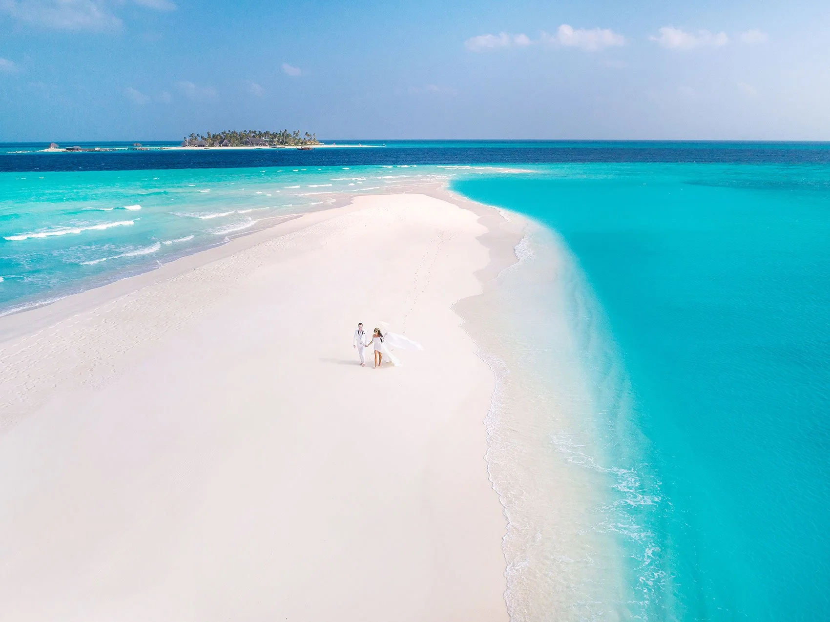 couple-walking-on-sandbank-maldives.jpg