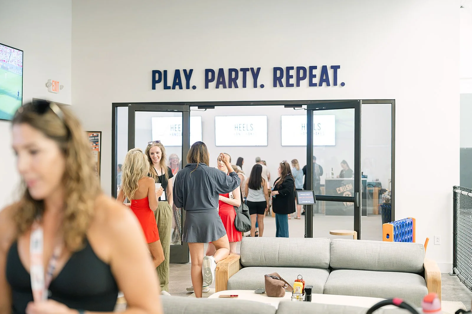 Professional women attend the Heels & Handshakes networking event at Crush Yard Nashville, building meaningful connections during a women’s business networking program.