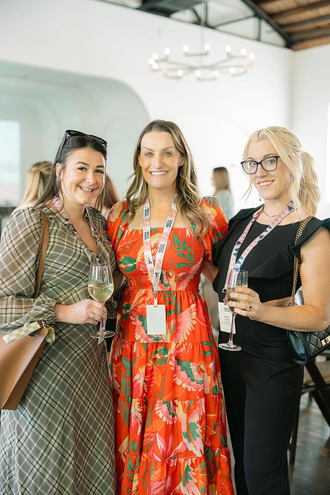 Three women smiling and networking at a Heels & Handshakes event in Nashville, Tennessee.