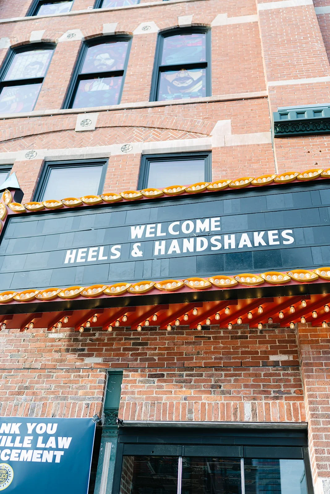 Heels and handshakes at Chiefs marquee sign.jpg
