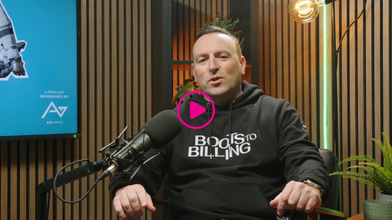 photo of a man wearing a dark hoodie sitting in a chair recording a podcast