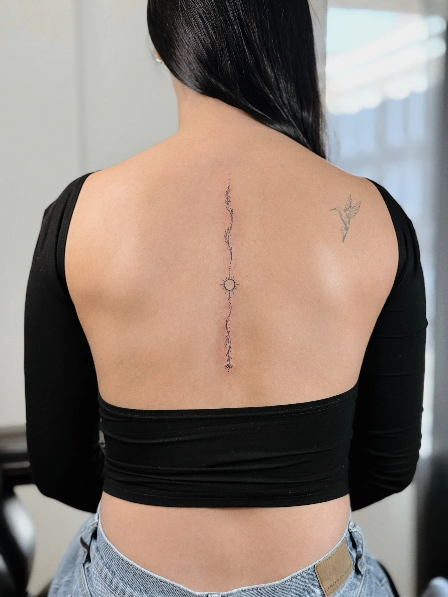 WISCONSIN FINE LINE SPINE TATTOO