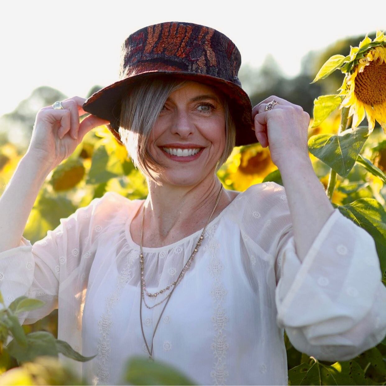 Beautiful evening at Gorby Sunflowers with great friend, Lori, modeling one of my nuno-felted hats. 
Model, Lori Zamora; Photographer, Brittany Metz. 
#millinery #millinerycouture  #feltsoright_dawnedwards #gorbysunflowers 
#handmadefelt #felting #we