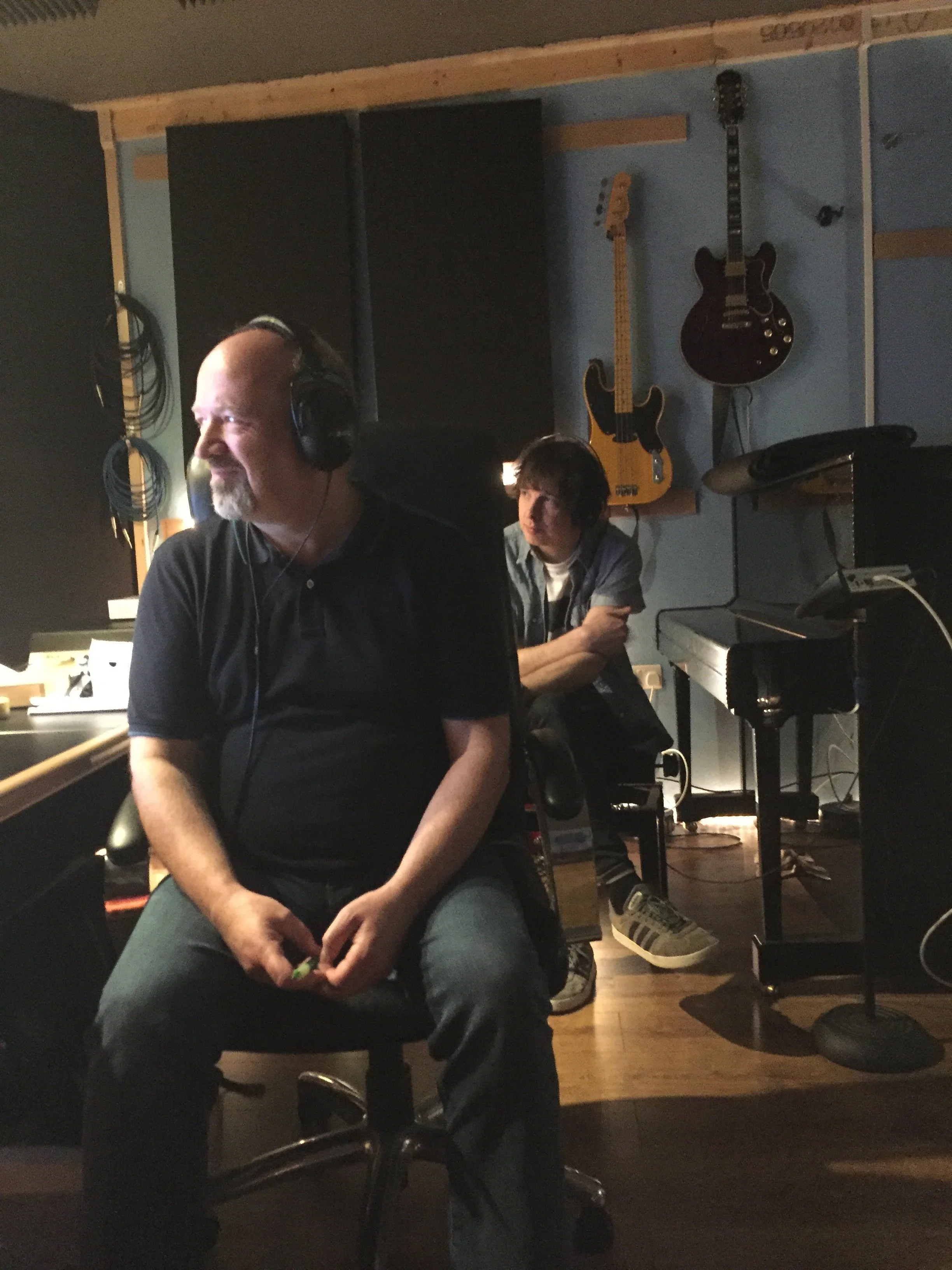 Recording engineer listens as the band plays through the song