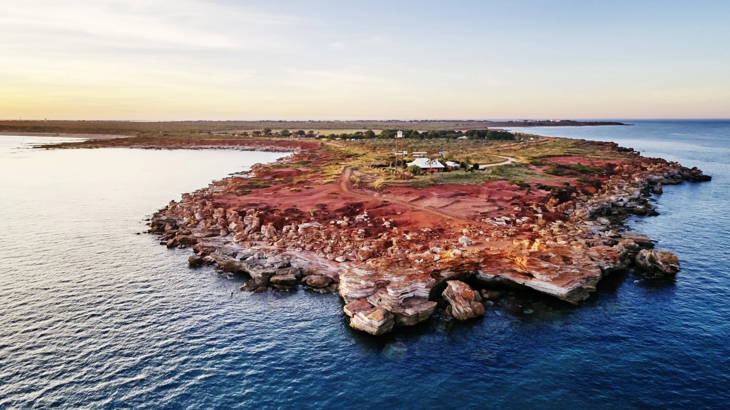 Red pindan cliffs and turquoise water near Broome
