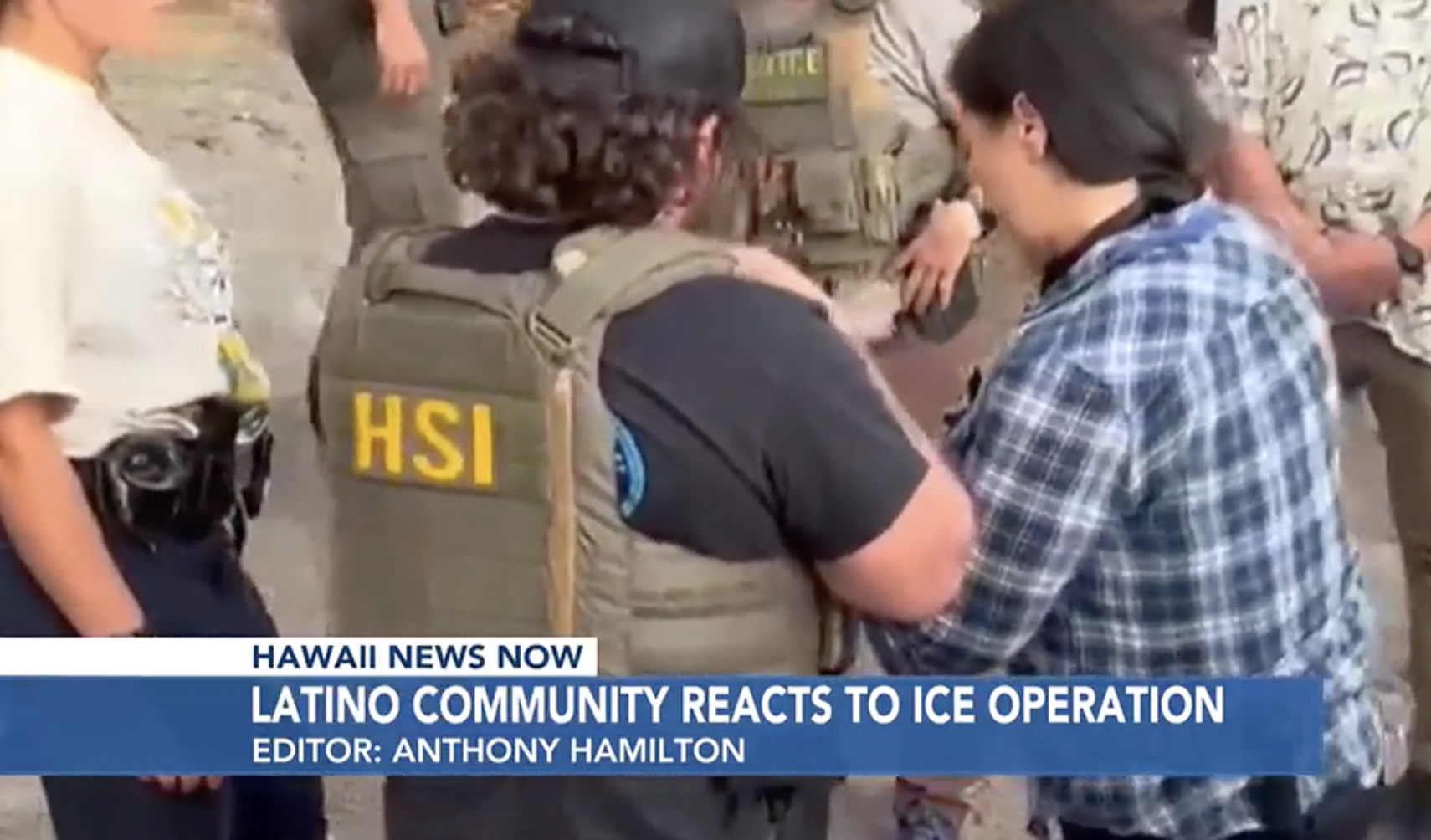 Hawaiian news broadcast showing a person in a cap and tactical vest with 'HSI' on it, talking to a woman wearing a blue plaid shirt, in a store or market setting.