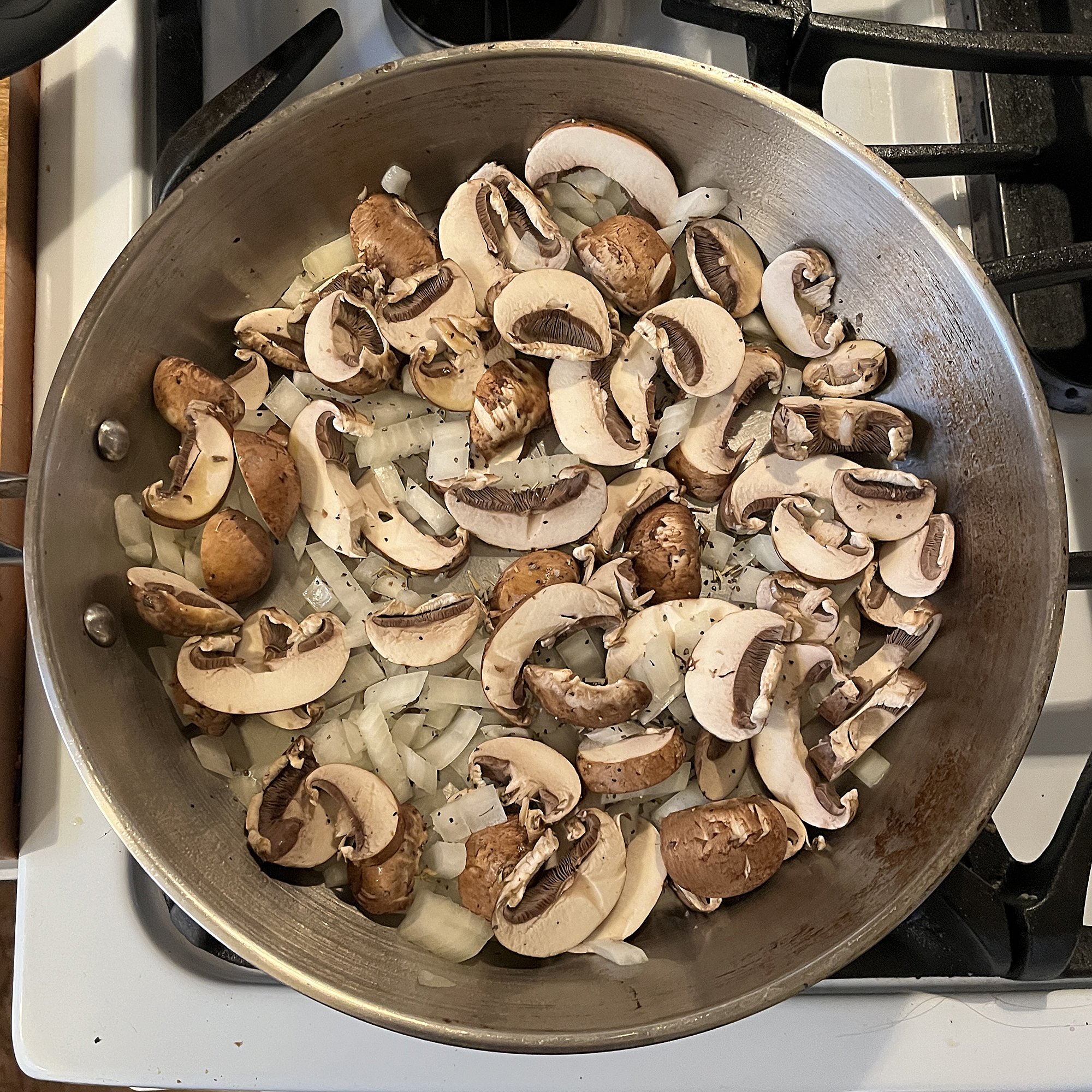 Meanwhile, sauté mushrooms, onions, and rosemary in olive oil.
