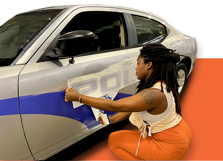 Tasha installing a vehicle wrap