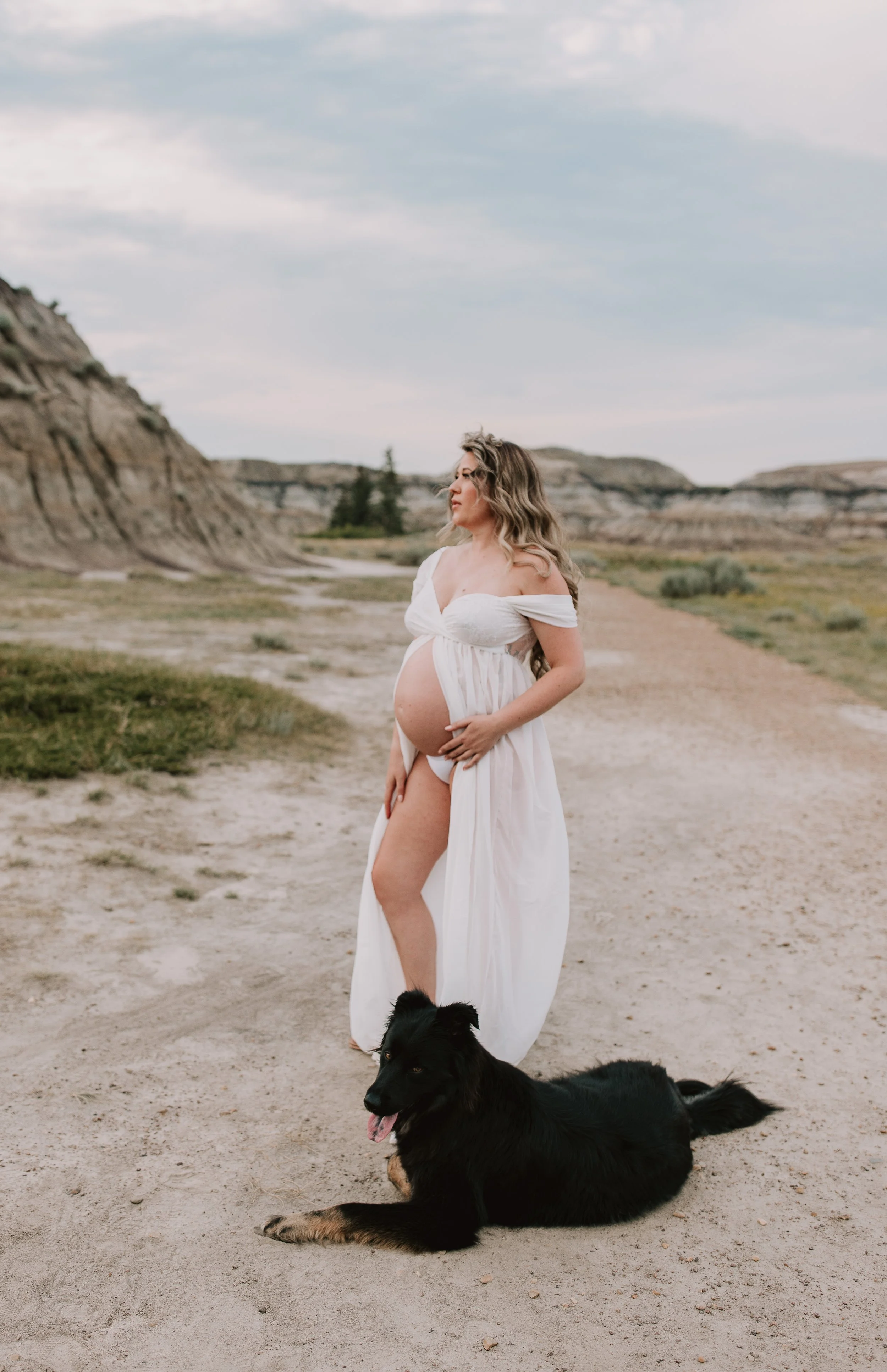 Pregnant woman posing in the Drumheller badlands during a maternity photoshoot