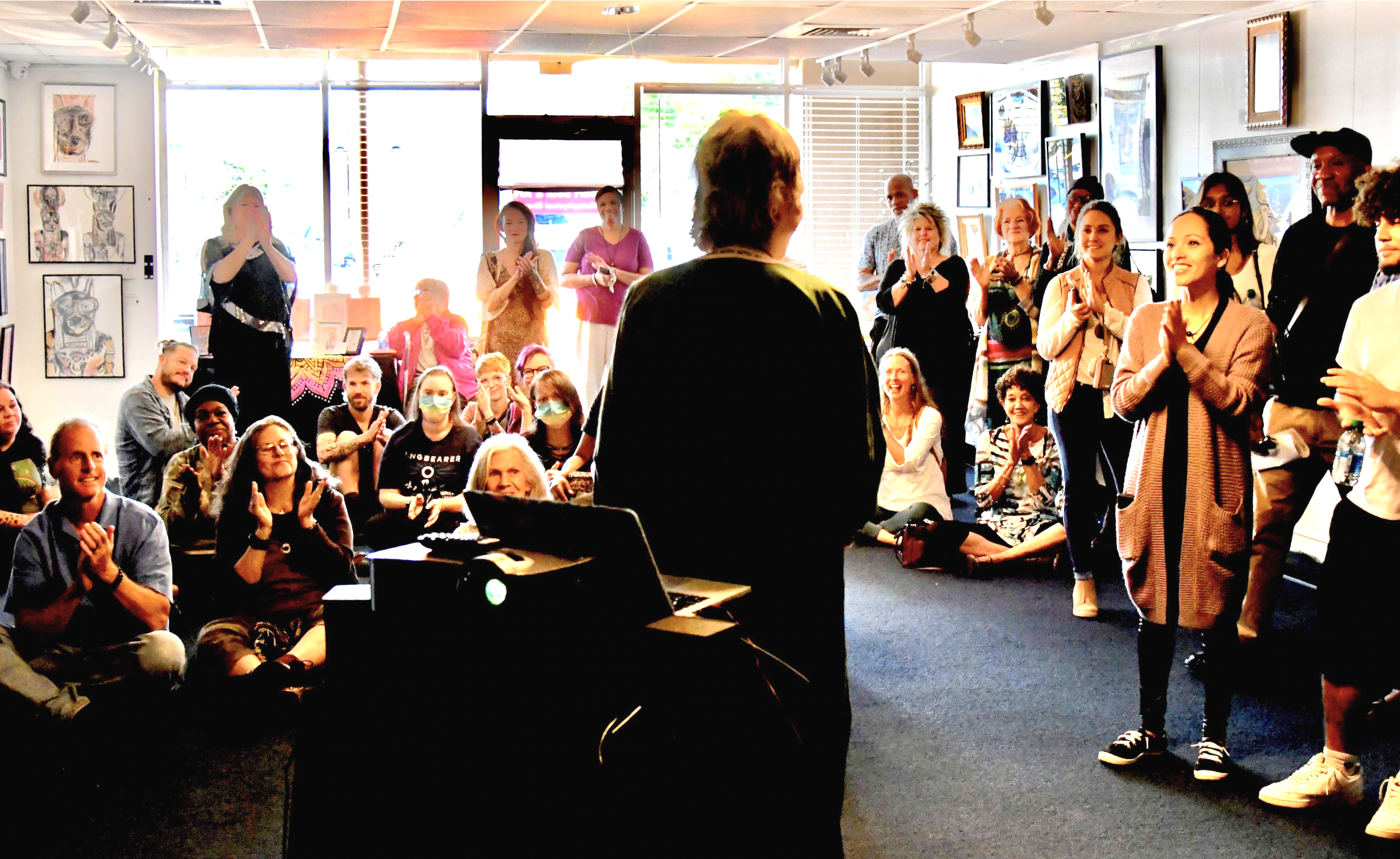 HS&A Over-shoulder MM speaking to public gathering 2022.png