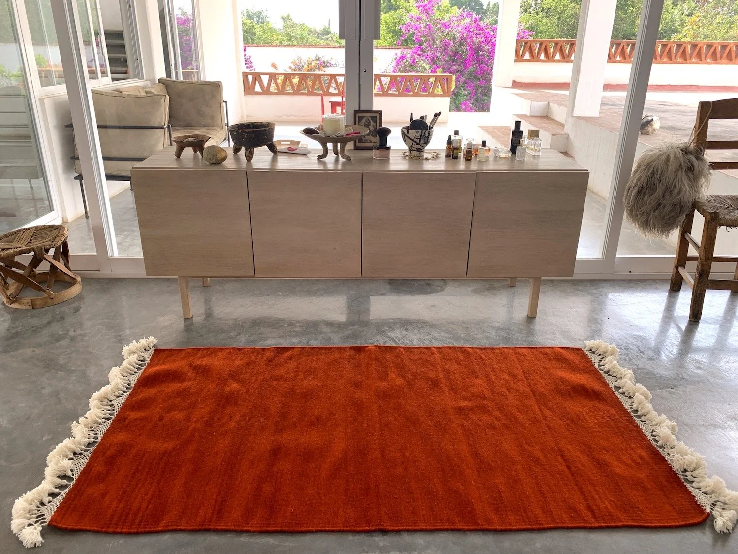 Mexchic handwoven wool rug with natural dyes and pom pom fringe made in teotitlan del valle oaxaca, the best shopping in oaxaca, guide clothing homewares boho tulum style contemporary Mexican design