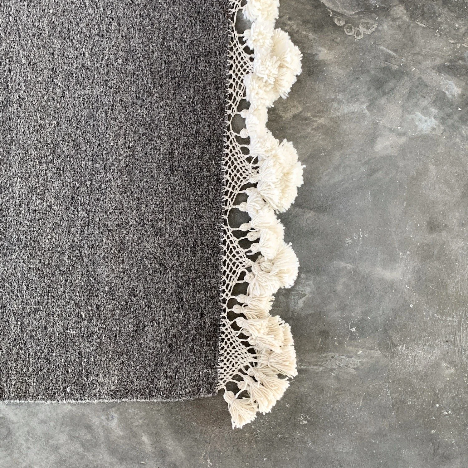 Mexchic handwoven wool rug with natural dyes and pom pom fringe made in teotitlan del valle oaxaca, the best shopping in oaxaca, guide clothing homewares boho tulum style contemporary Mexican design