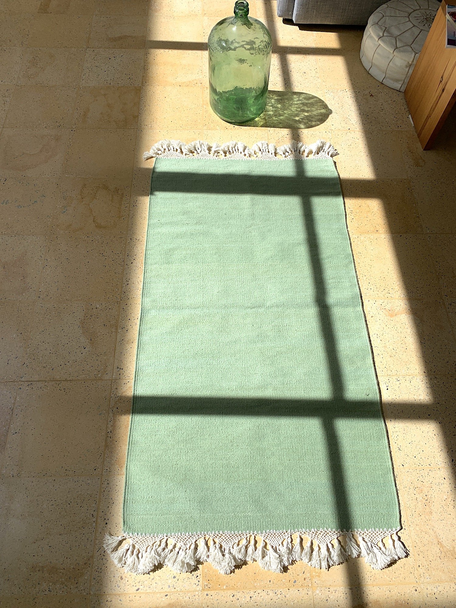 Mexchic handwoven wool rug with natural dyes and pom pom fringe made in teotitlan del valle oaxaca, the best shopping in oaxaca, guide clothing homewares boho tulum style contemporary Mexican design