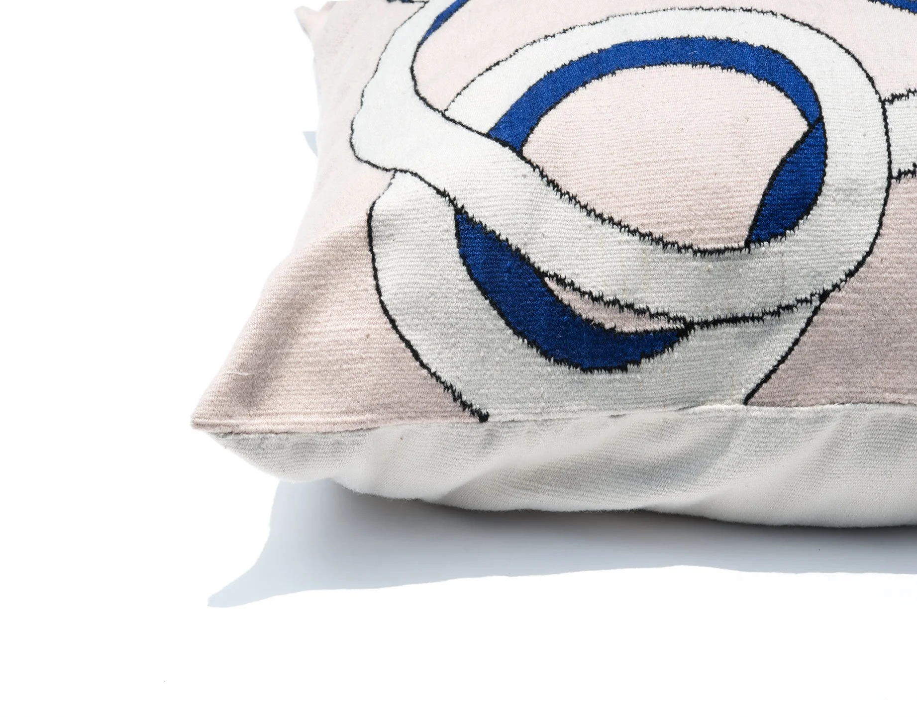 Mexchic handwoven floor pillow curvy loops pink blue cream contemporary craft Quetzalcoatl plumed serpent Oaxaca teotitlan del valle Mexican design