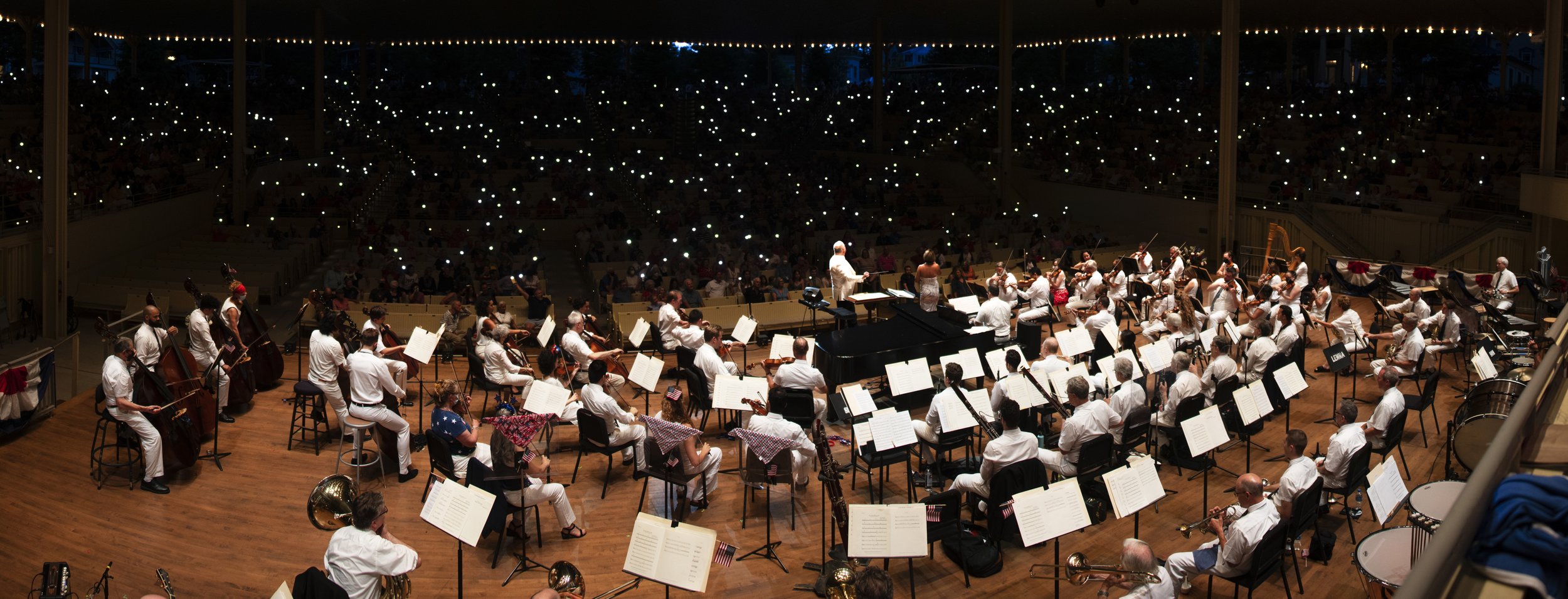 The Chautauqua Symphony Orchestra, Led by Conductor Stuart Chafetz, and accompanied by soprano Dee Donasco, play during an Independence Day Celebration on July 4, 2022 in the Amphitheater. During the celebration, the orchestra performed various Ameri