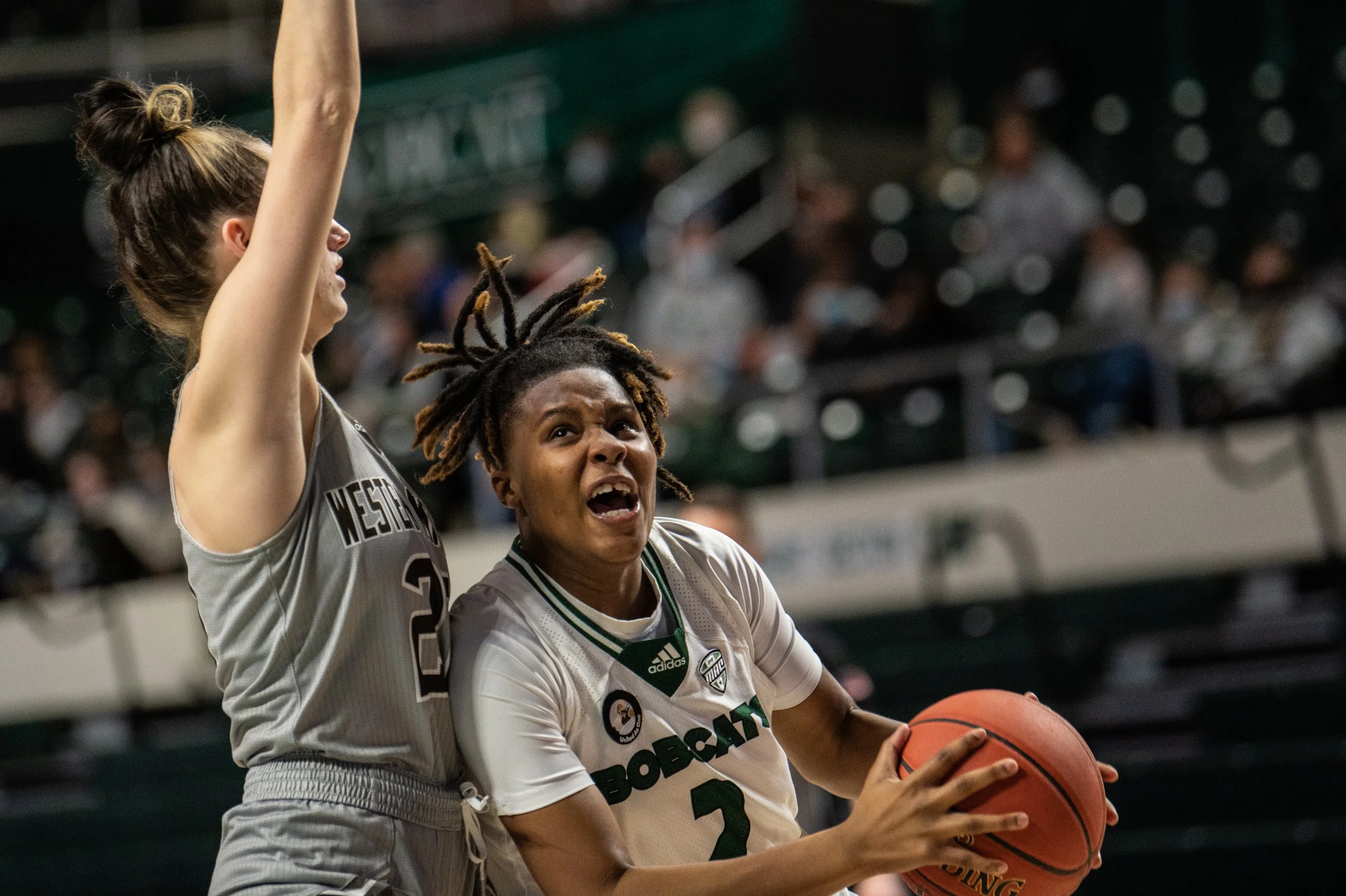 Ohio University Guard Yaya Felder (2) drives towards the hoop while being guarded by Western Michigan University guard Lauren Ross (22) at The Convo in Athens, Ohio, on Feb. 12, 2022.