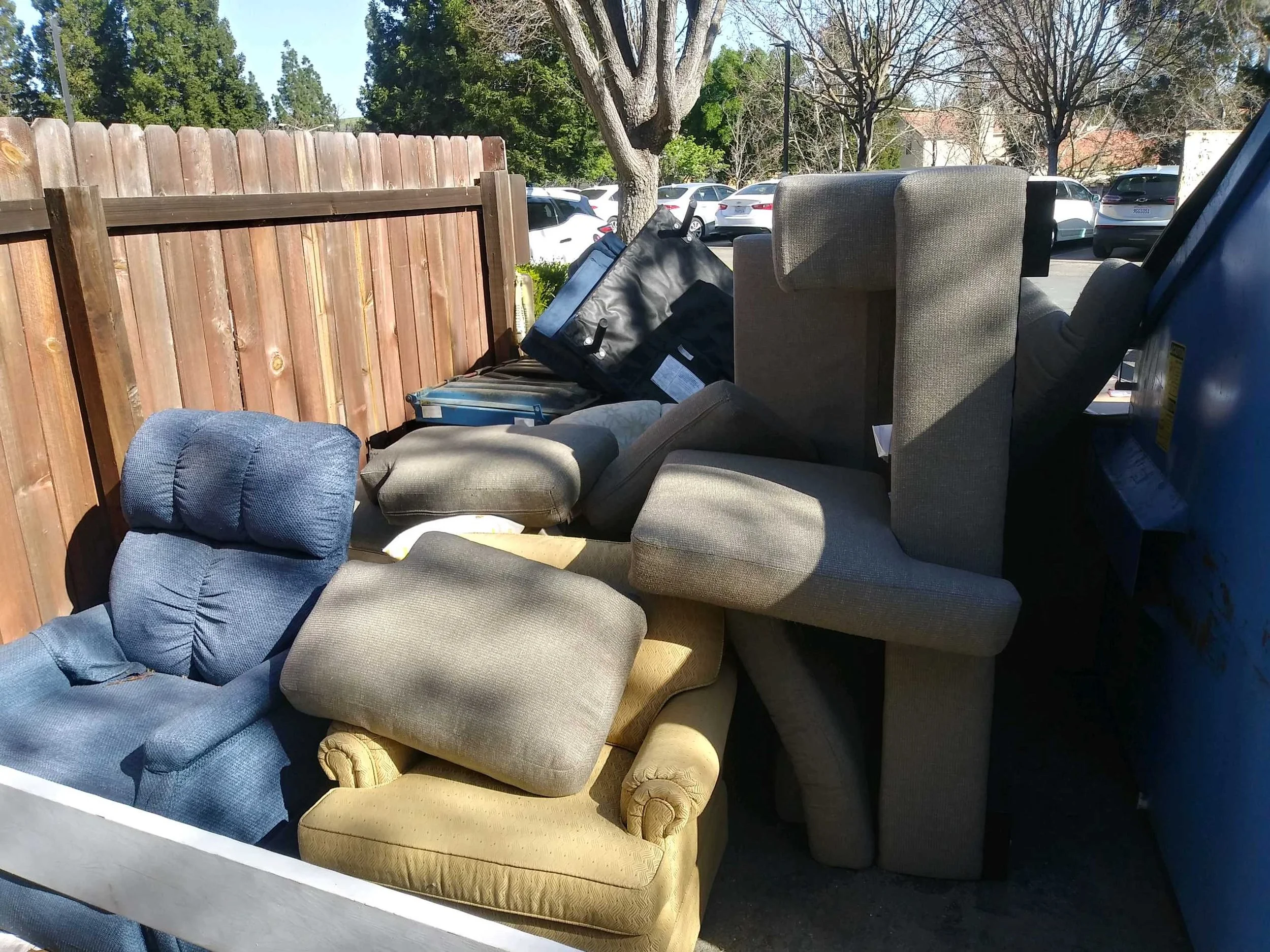 Pile of various used chairs and couches outside for junk removal pick up. D&V’s Same day furniture removal. Sofa and recliner disposal. Sectional haul away service.