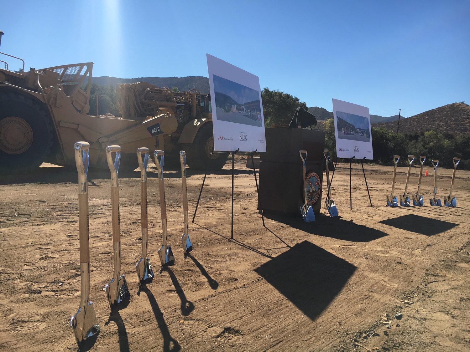 Sycuan-Square-Ground-Breaking-Ceremony-shovels-lined-up-in-front-of-construction-vehicles.jpg