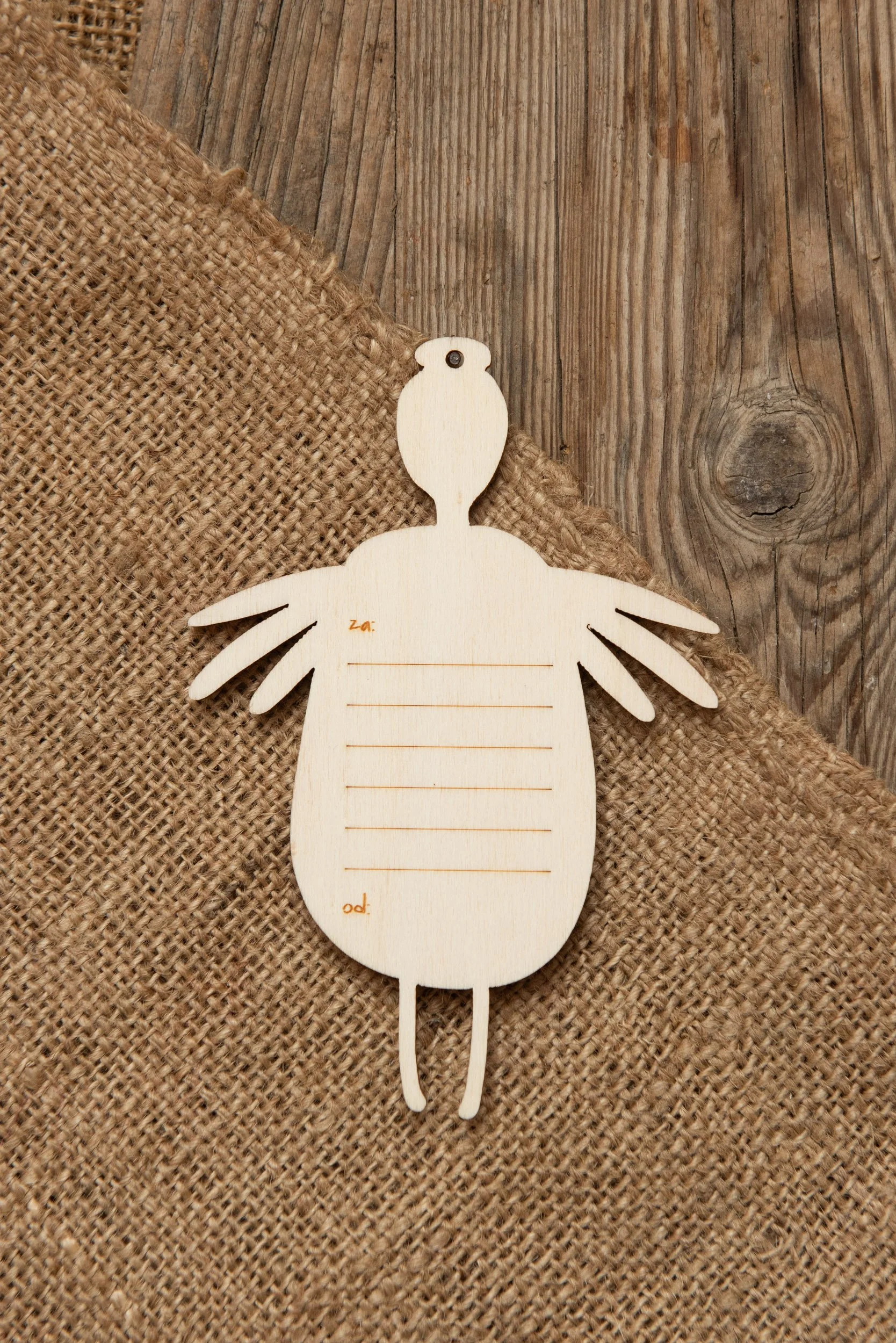 A wooden fairy-themed greeting card adorned with ribbons, flowers, and writing lines on the back. It comes with a string for hanging and a neutral-colored envelope.