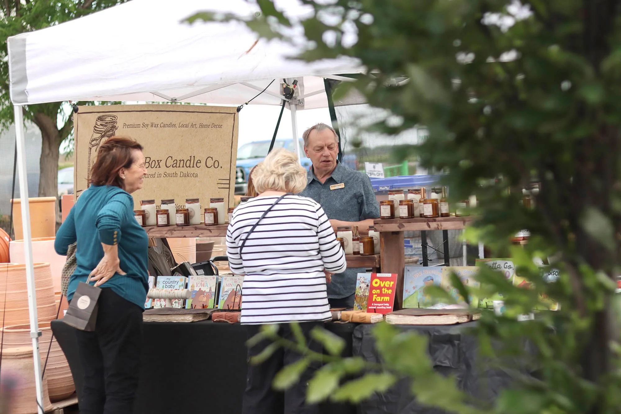 people talking about books at a booth