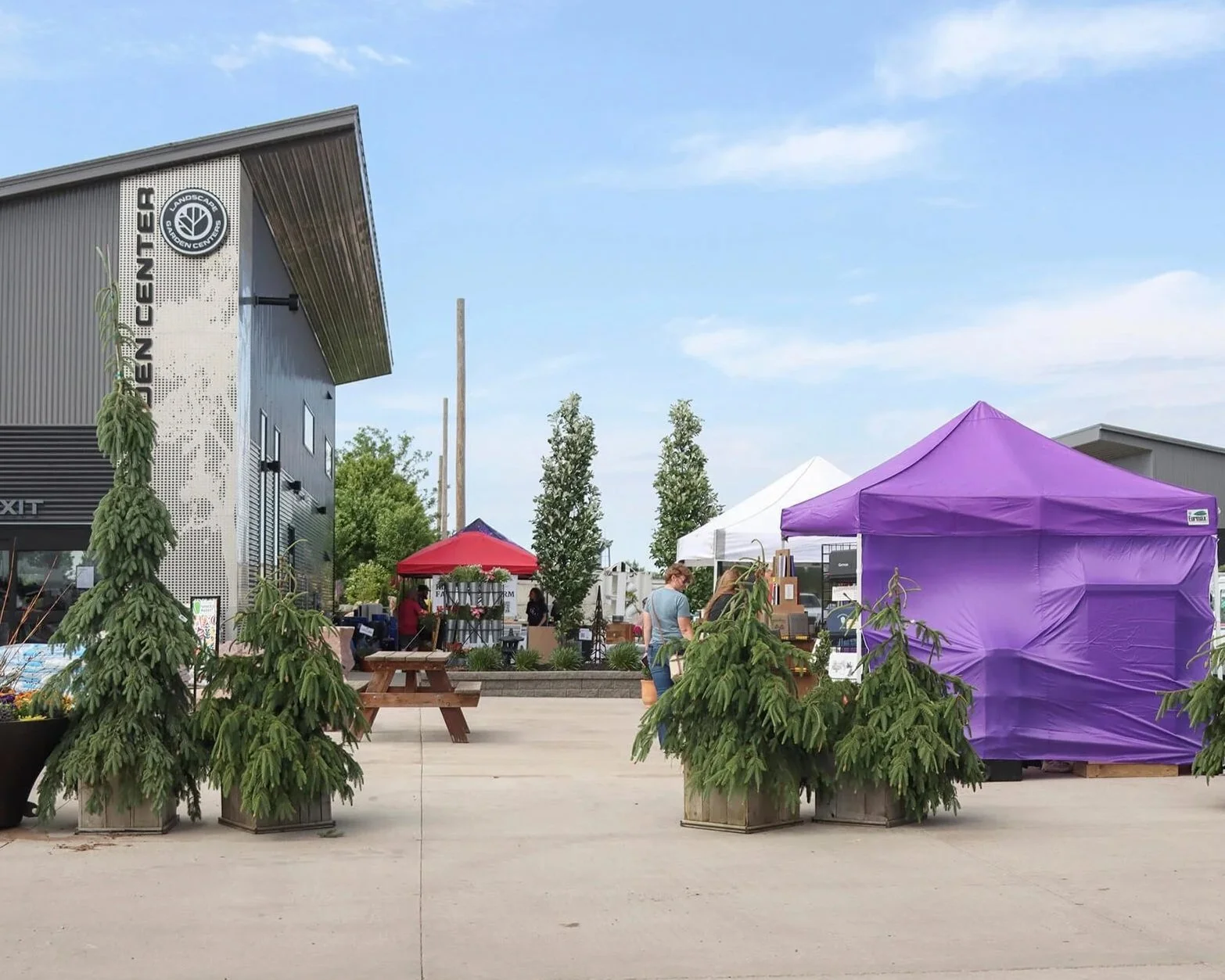 the outside of landscape garden center with tents set up