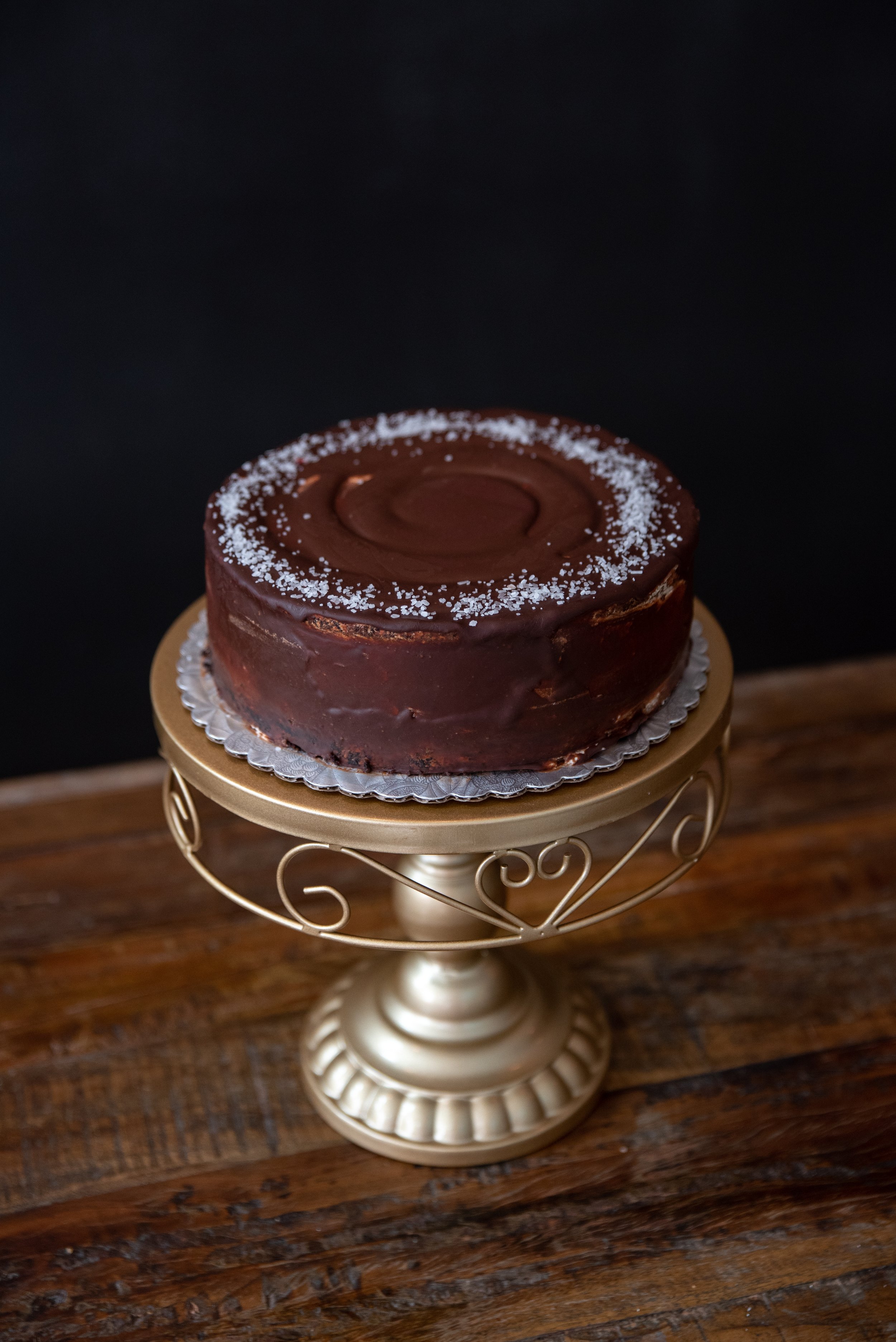 SEA SALT CARAMEL - Chocolate cake with homemade caramel filling. Polished with dark chocolate ganache and garnished with Kosher Sea Salt.