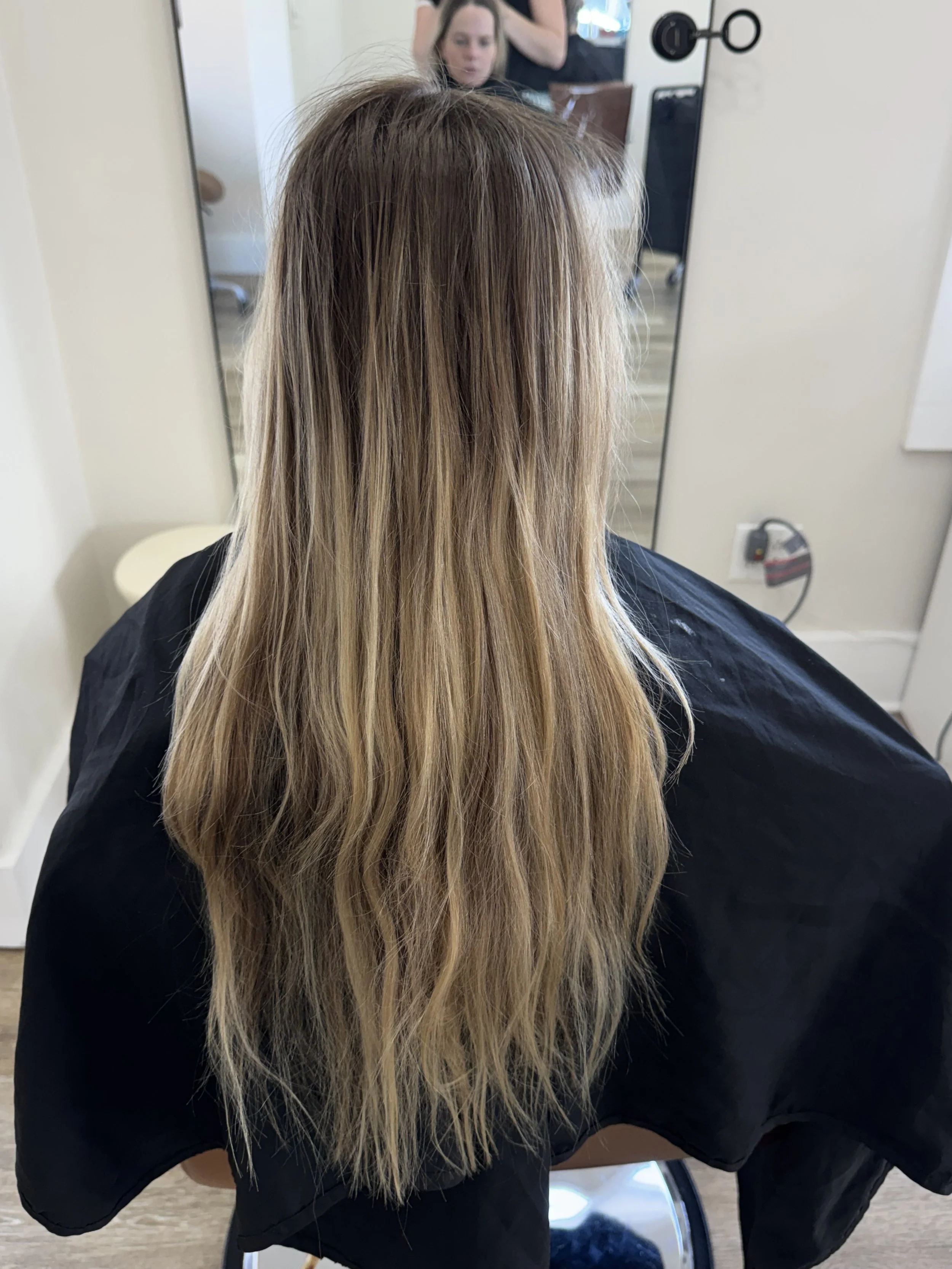 Before one row of seamless hair extensions in Grand Haven, MI: long blonde hair, thin through the ends