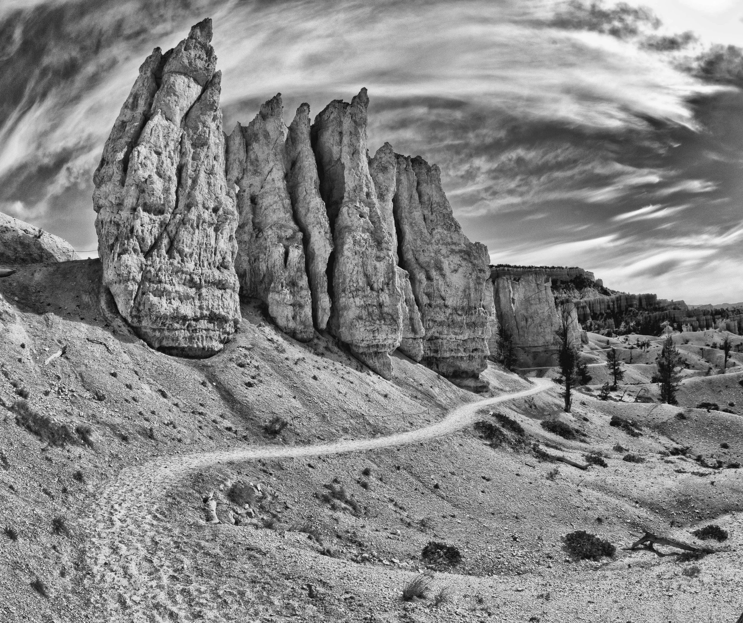 Bryce Trail and Hoodoos.
A winding trail disappears among the hoodoos, drawing the traveler into the heart of the canyon.