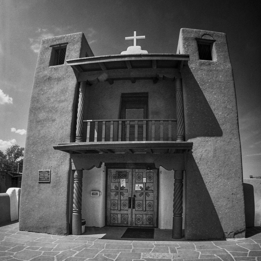 San Francisco de Asís Mission Church — Ranchos de Taos, New Mexico.
The adobe towers of San Francisco de Asís Mission Church rise with quiet strength, their rounded forms softened by sun, mud, shadow, and time.