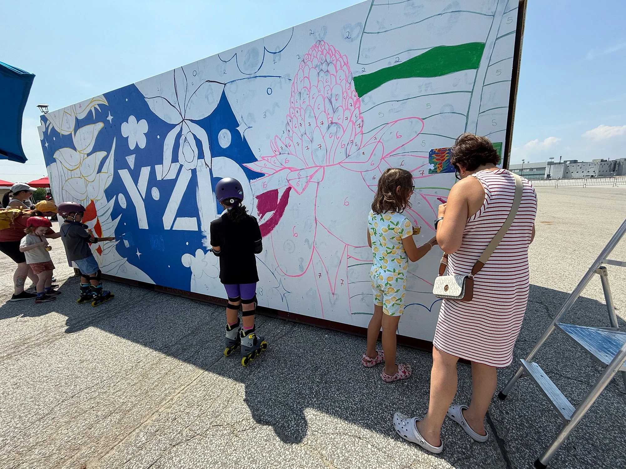 Community members participating in a collaborative public art project in Toronto