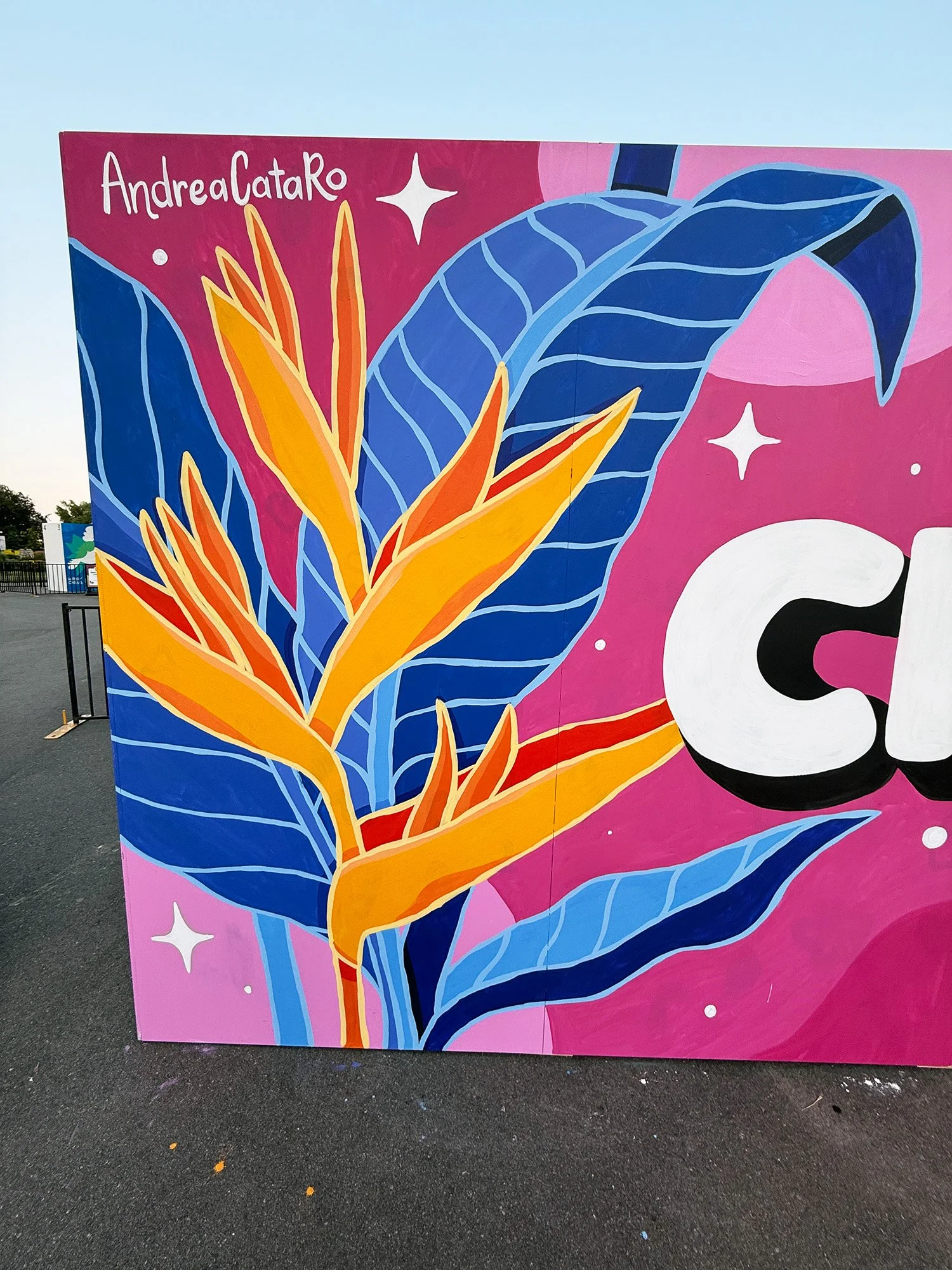 Close-up of tropical leaves and flowers painted in a colourful mural by AndreaCataRo.