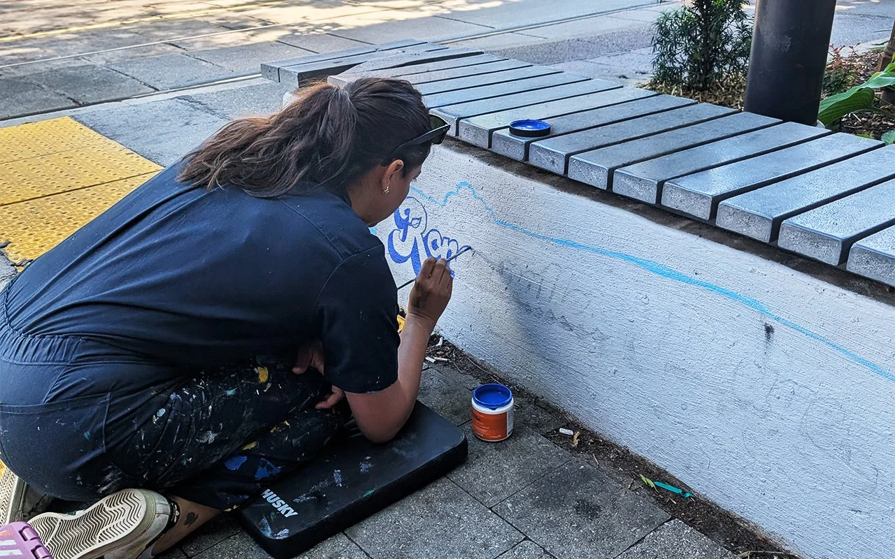 Lettering mural showing how words are planned before being painted on a wall.