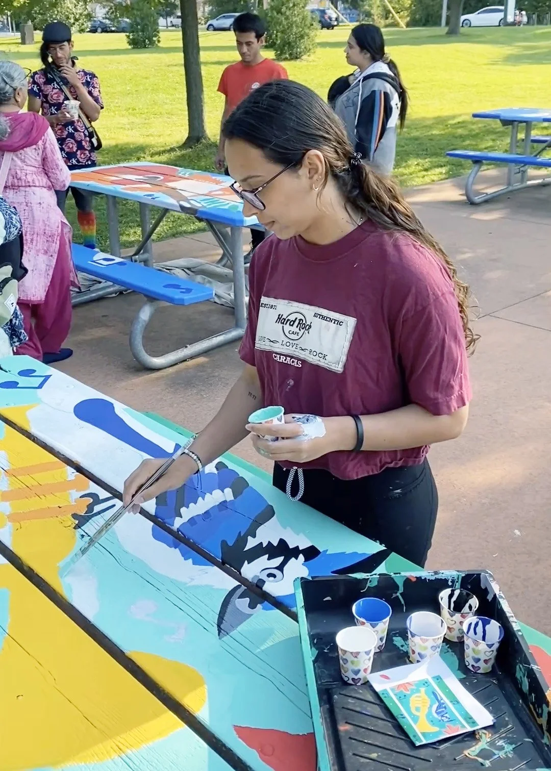 Community engaged public art project featuring painted benches and tables in Toronto