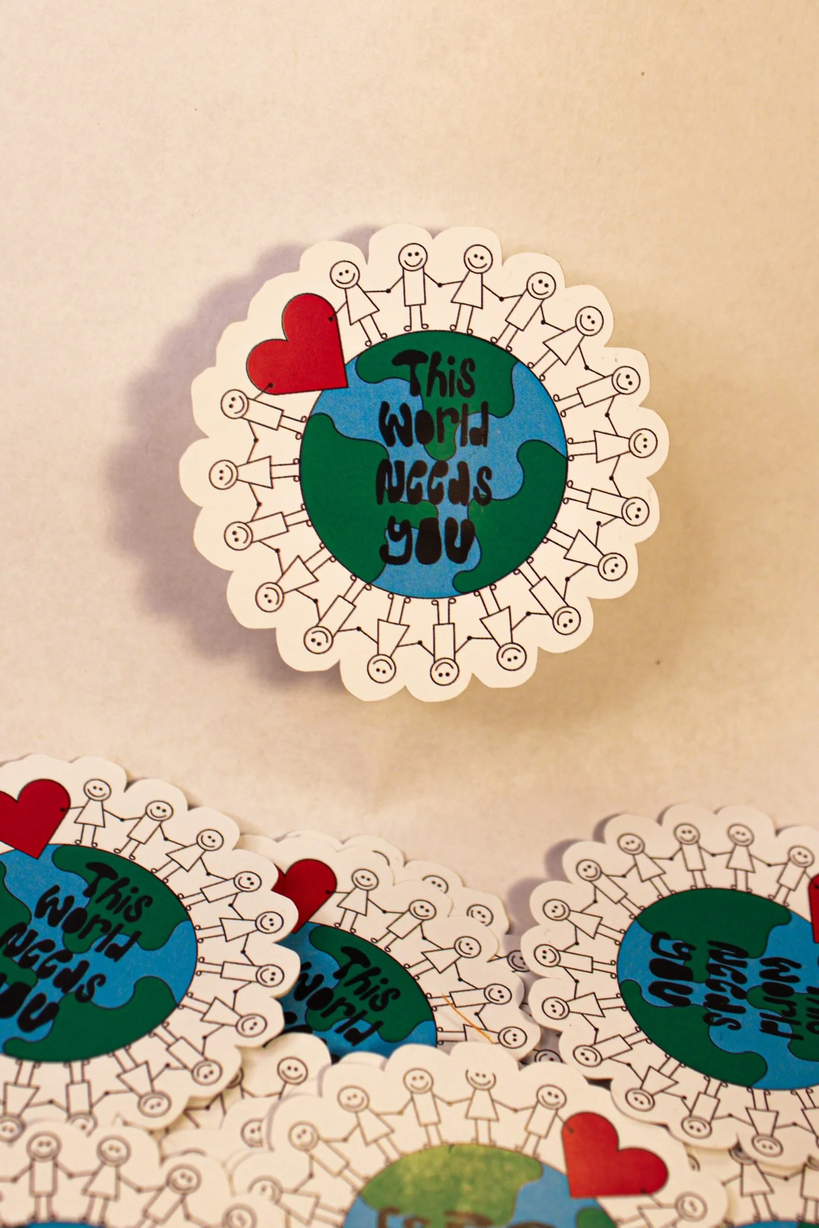 This World Needs You Sticker