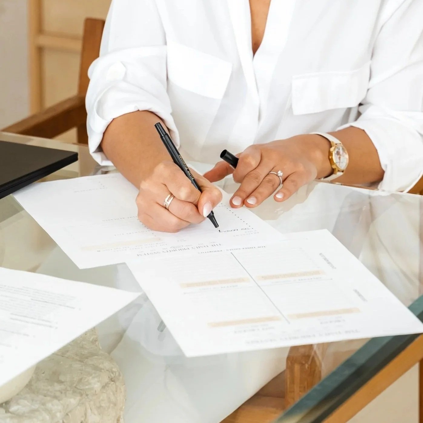 Health and wellness practice owner reviewing bookkeeping paperwork