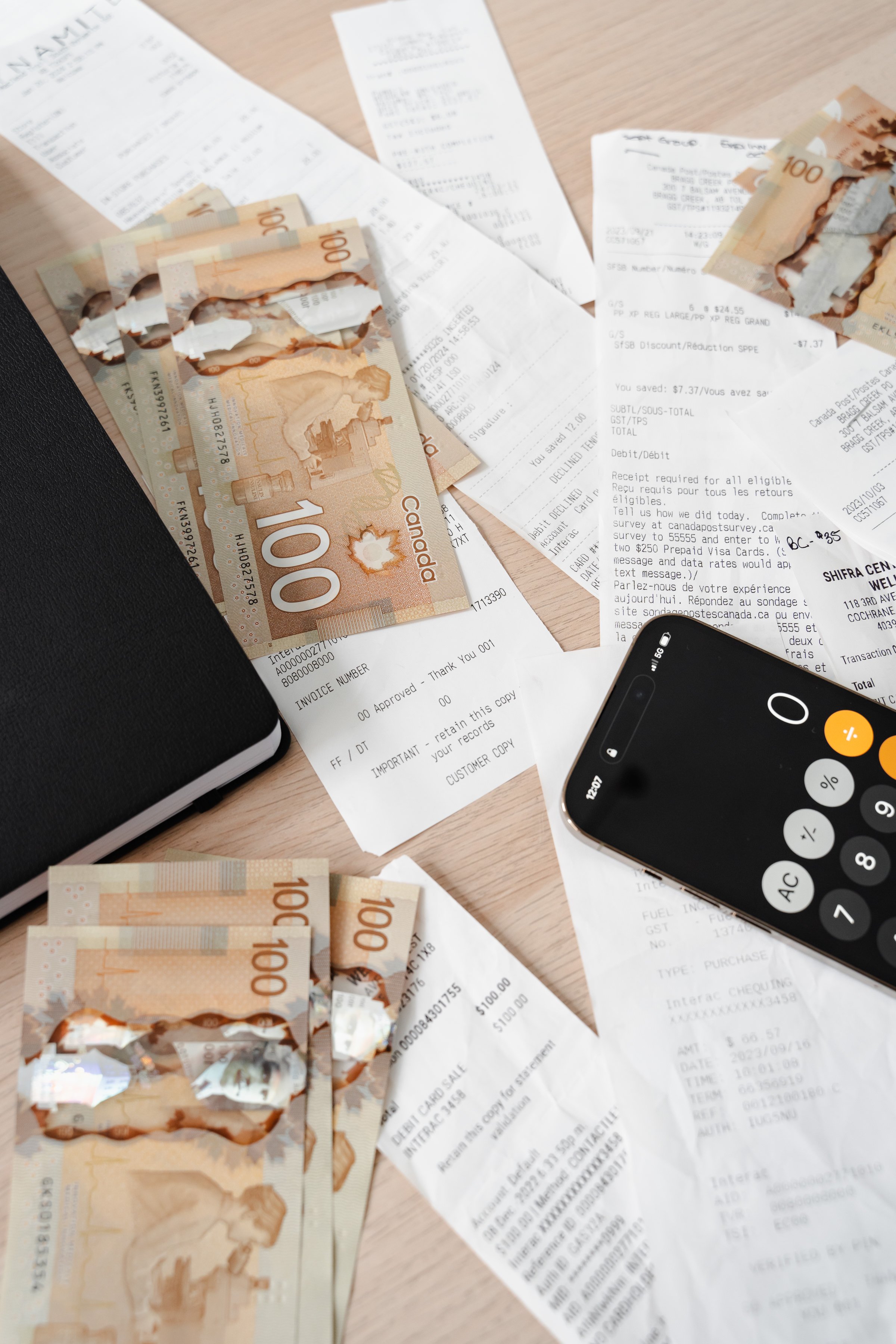 Calculator and cash for monthly bookkeeping and financial reporting