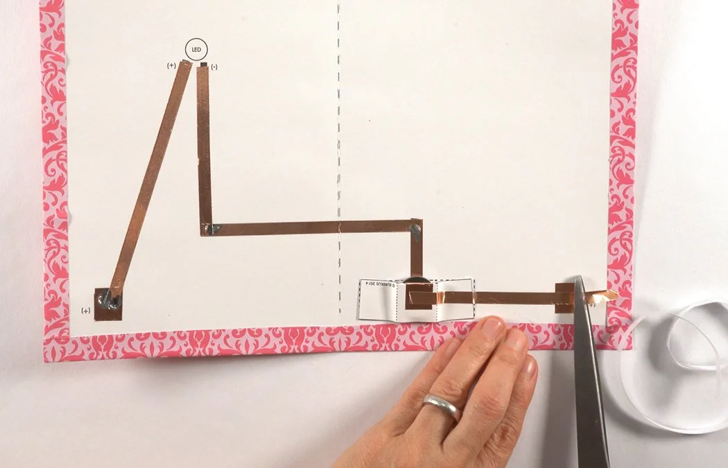 Place the copper over your last grey (+) line. Stick it to the right corner copper switch pad. Trim the copper.